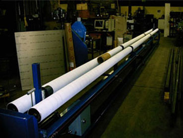 33' Surface Winder 
Plastic sheet rolled onto 6" OD core.