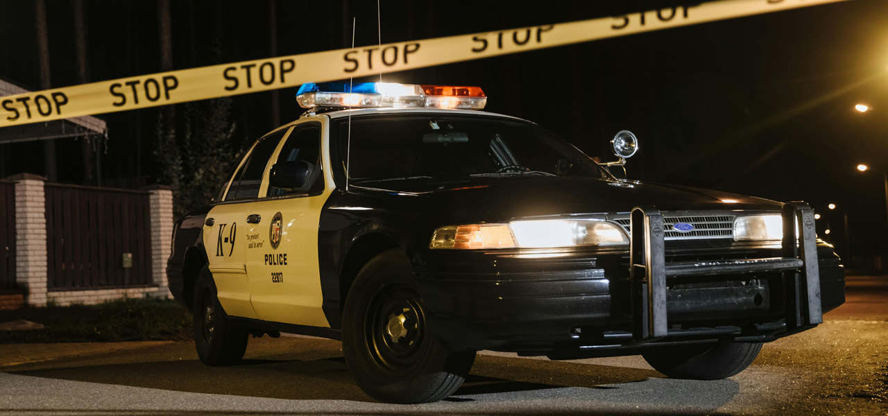 A police car with caution tape in front of it