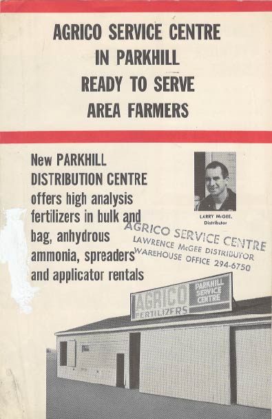 Interior of McGee Farm Services store with shelves of gardening supplies, canned goods, and plants.