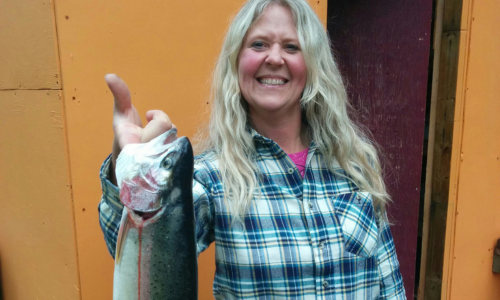 Woman in Blue Flannel With Her Catch