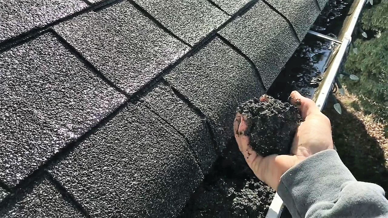 Cleaning gutters by hand
