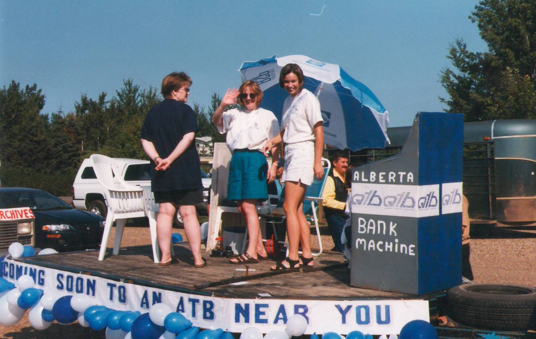 This is the ATB float in the 1998 Fort Vermilion Fall Fair. The float boasts a new bank machine "coming soon to an ATB near you". We are unsure who the ladies on the float are and would love your insight as to who they may be.
Cranna Toews, Marilee / 999.56.171
--EDIT--
L-R Kathy Morris, Cheryl Dzerdz, Unknown