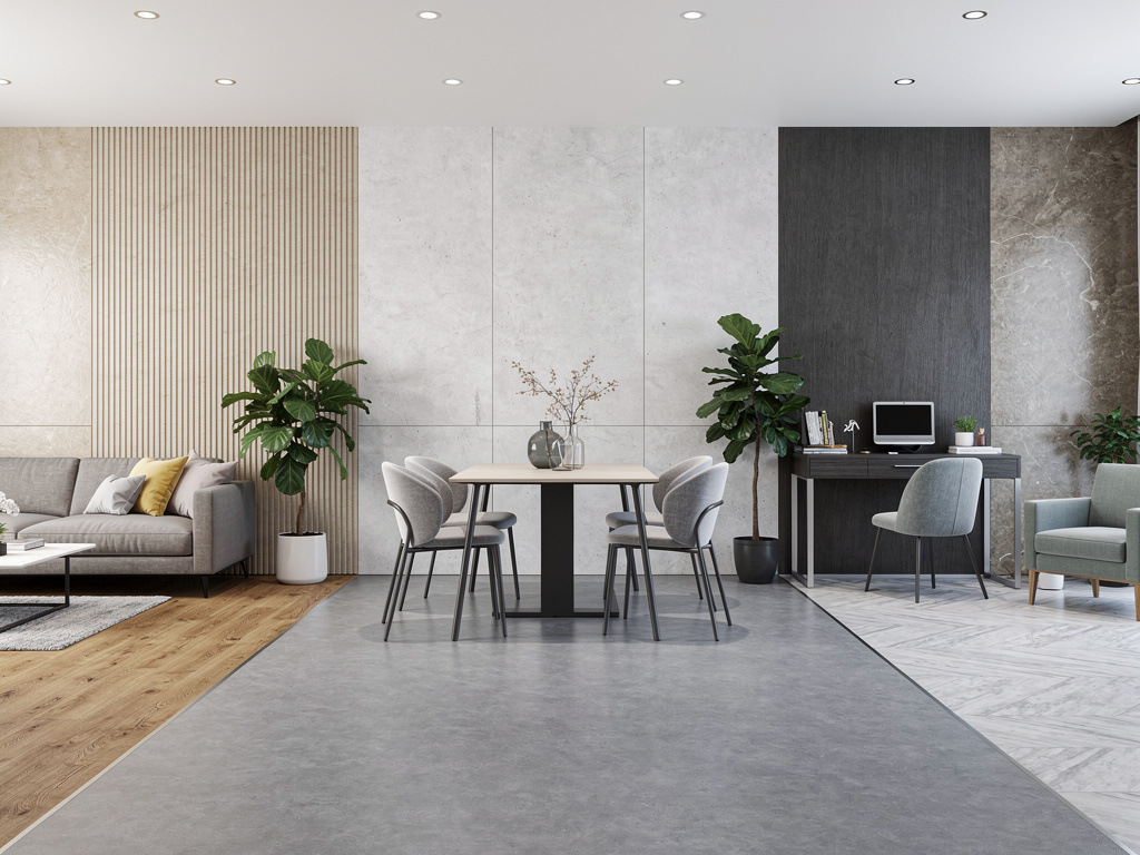 Modern open-plan living room, dining area, and home office with concrete walls, wood accents, indoor plants, and minimalist furniture