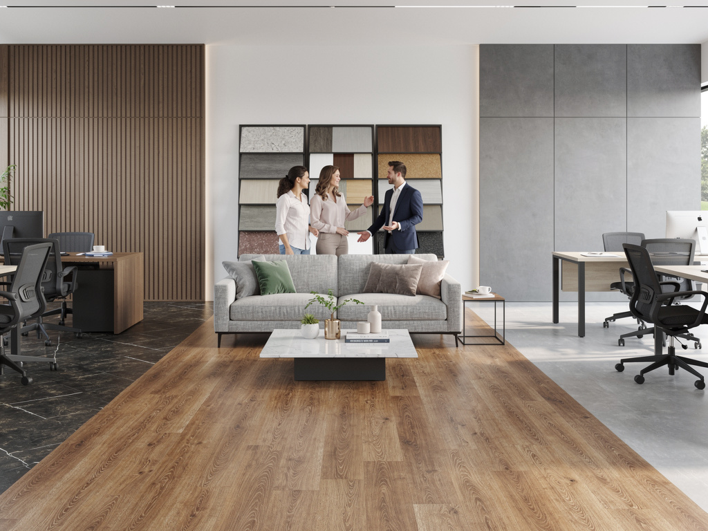 Modern interior design showroom office with wood flooring, gray sofa, material samples, and designers discussing finishes