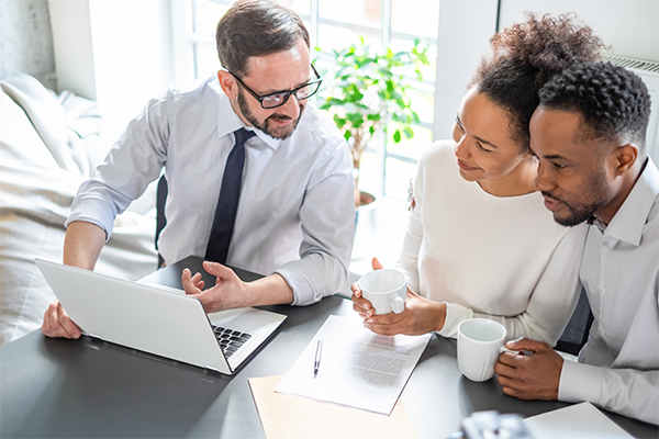 couple discussing insurance policies with agent