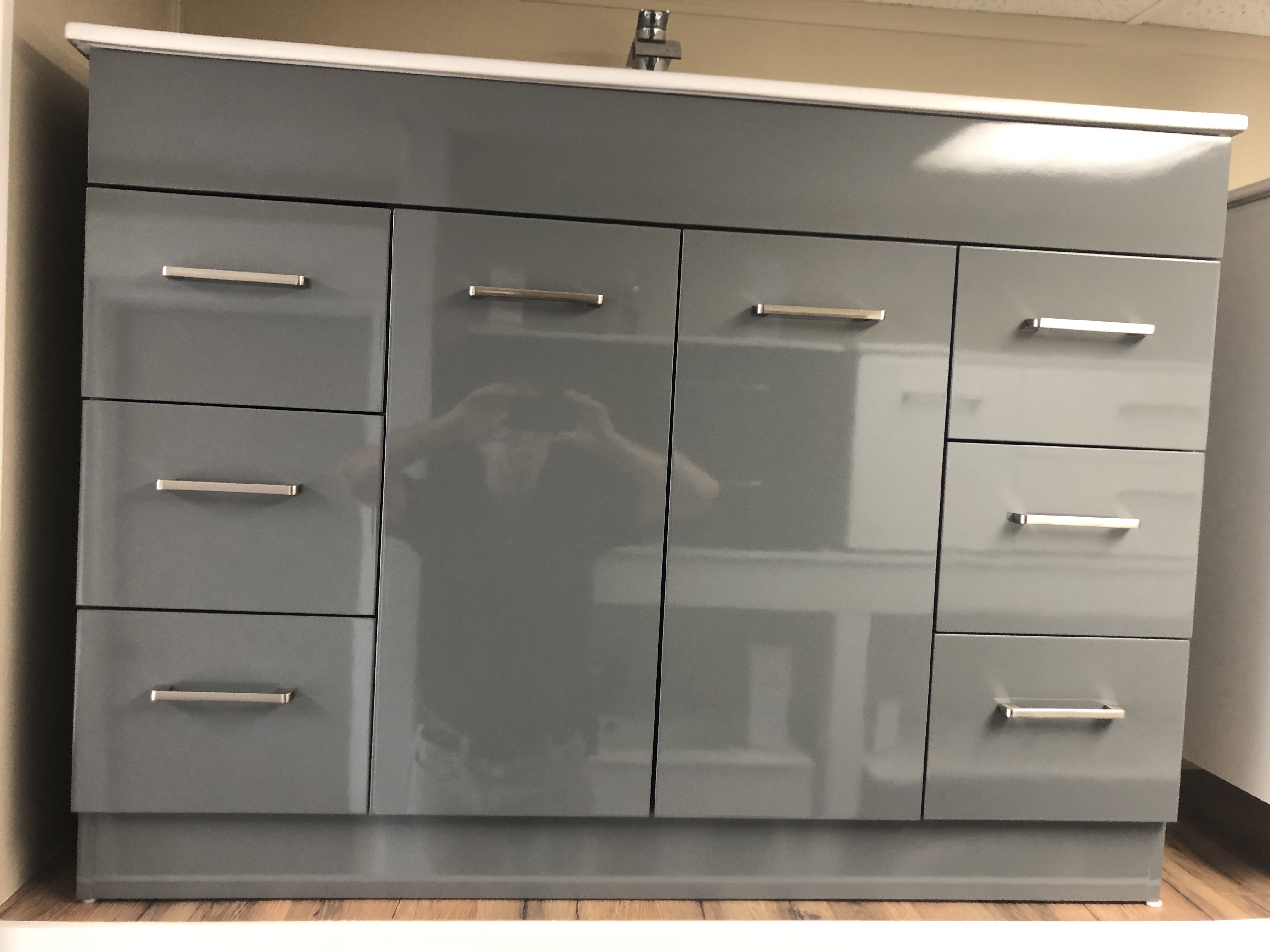 Modern bathroom with a double sink vanity, backlit mirror, plants, and towels, featuring a minimalist and elegant design.