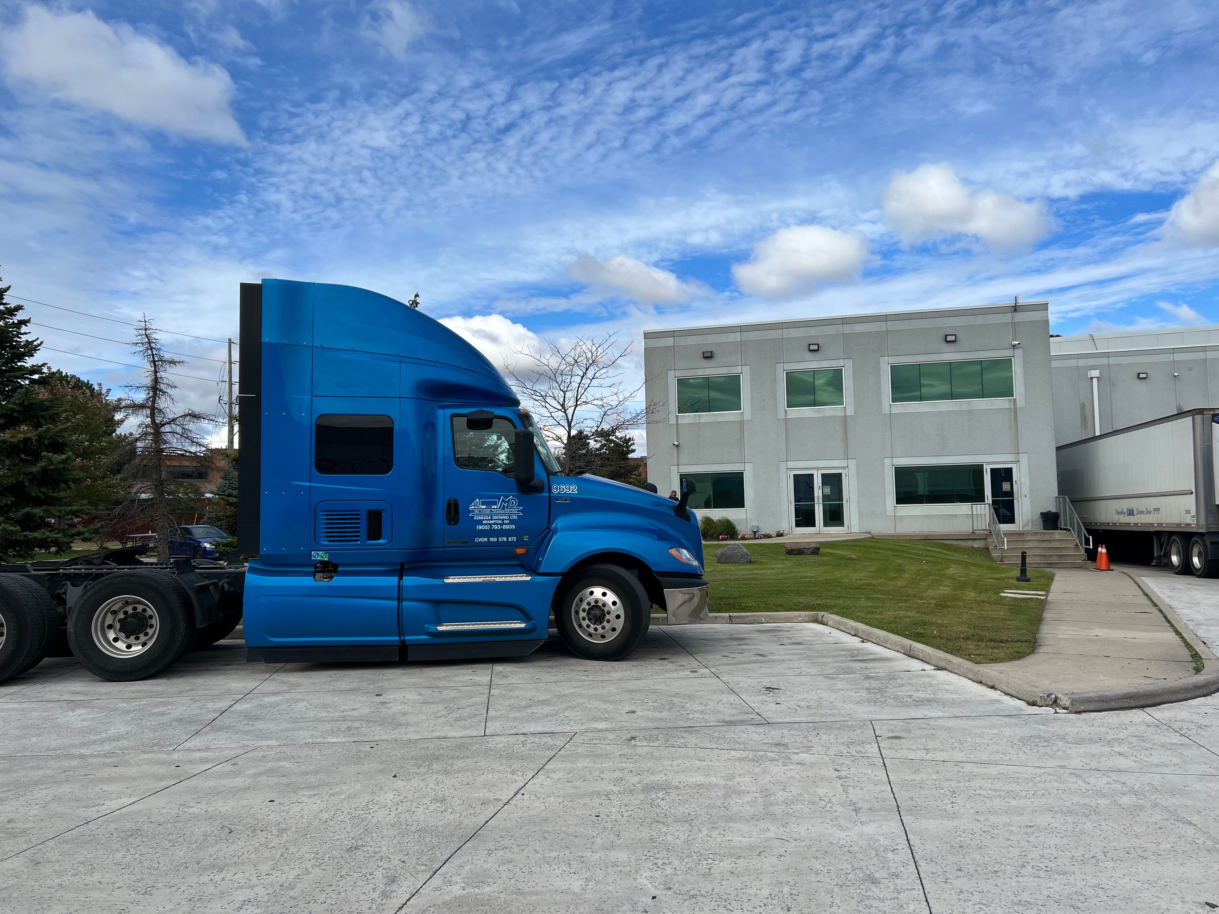 woman and child standing in front of yellow bus in car park