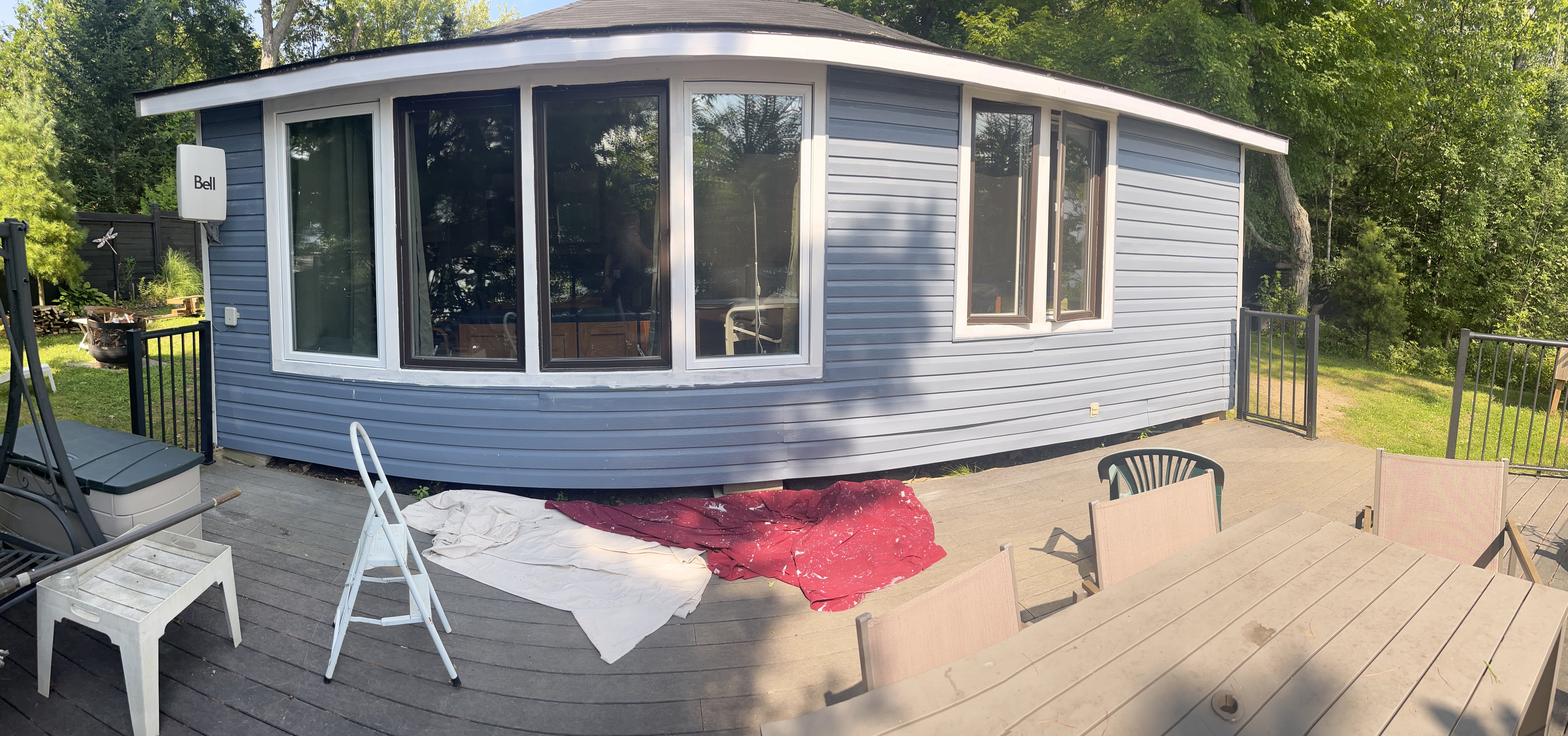 New windows are installed. Siding is painted.