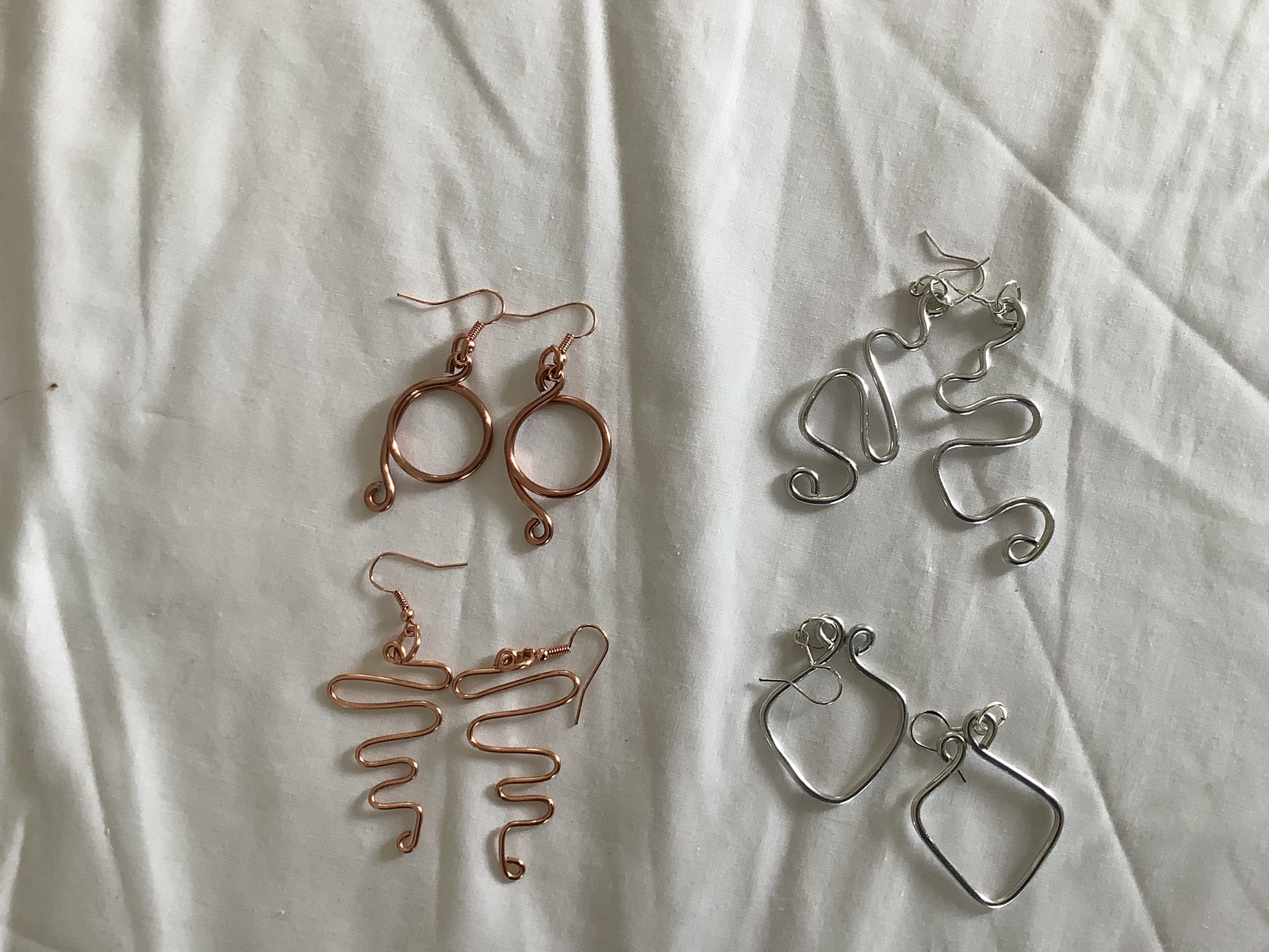 Funky earrings are a hit for the young of heart. They are handcrafted in aluminum silver or copper color. They do not always match, hence they are funky.   $30..00 pr.