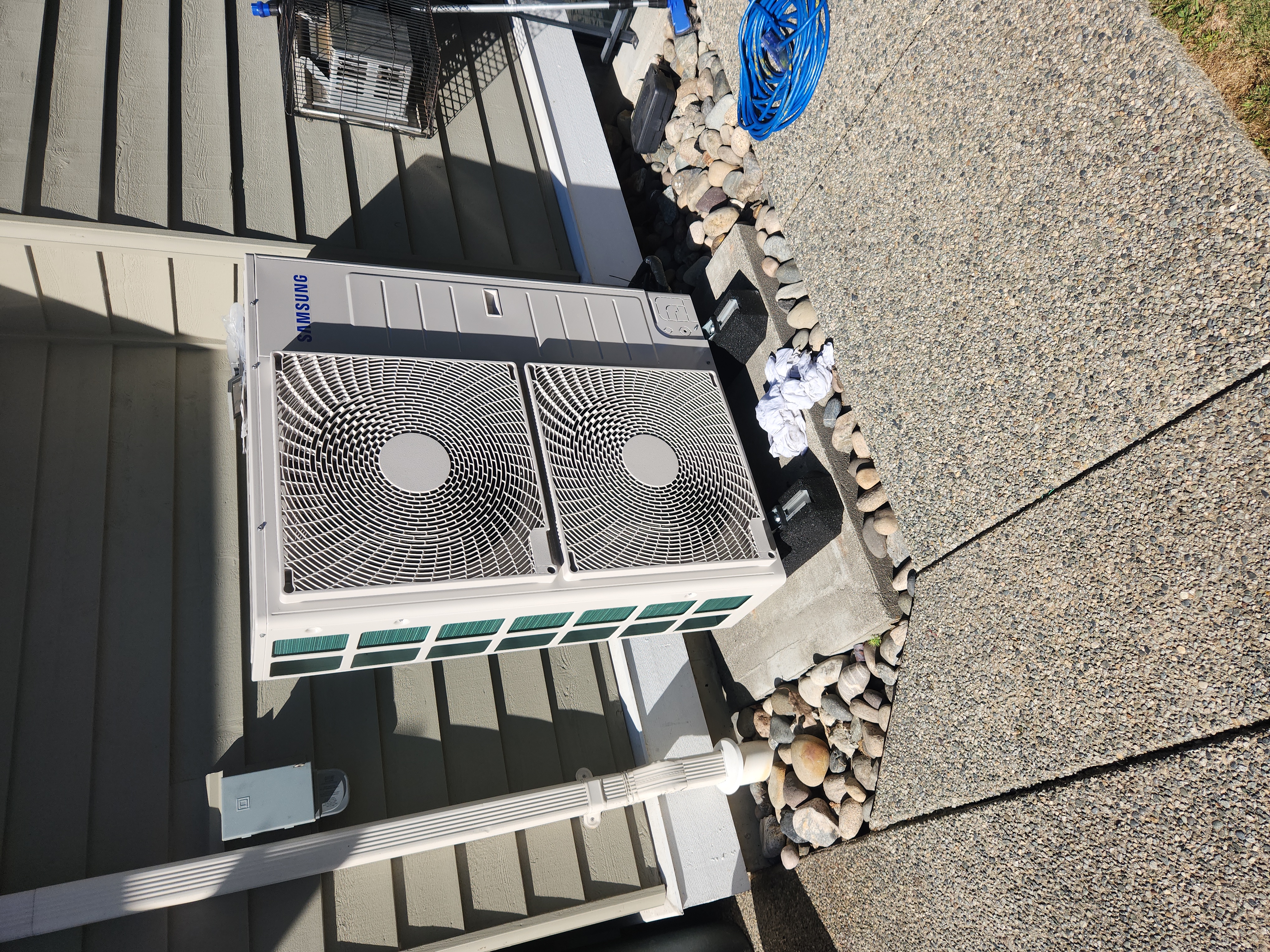 Blue and yellow heating and cooling service van in a garage.