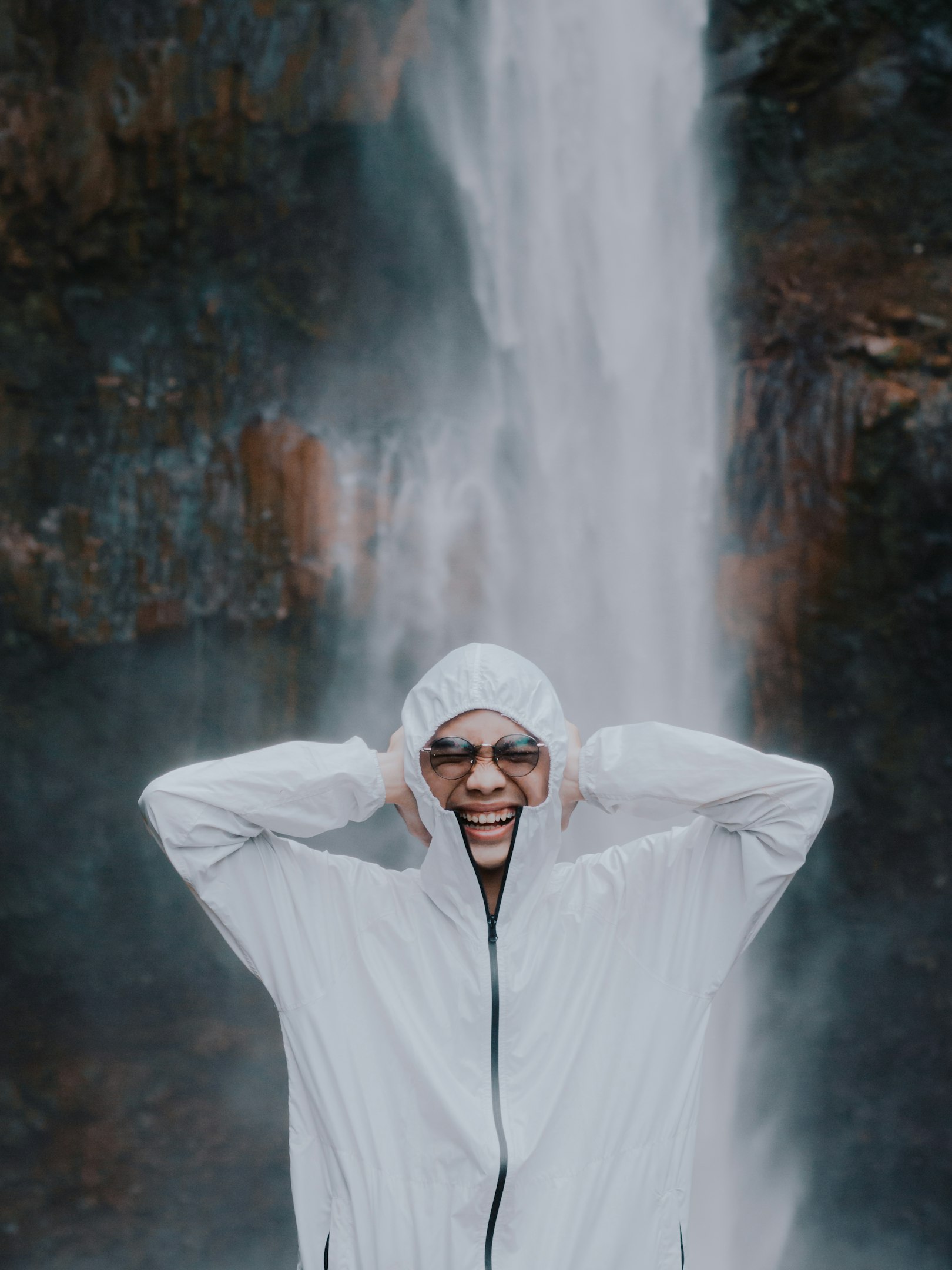 a person standing in front of a waterfall