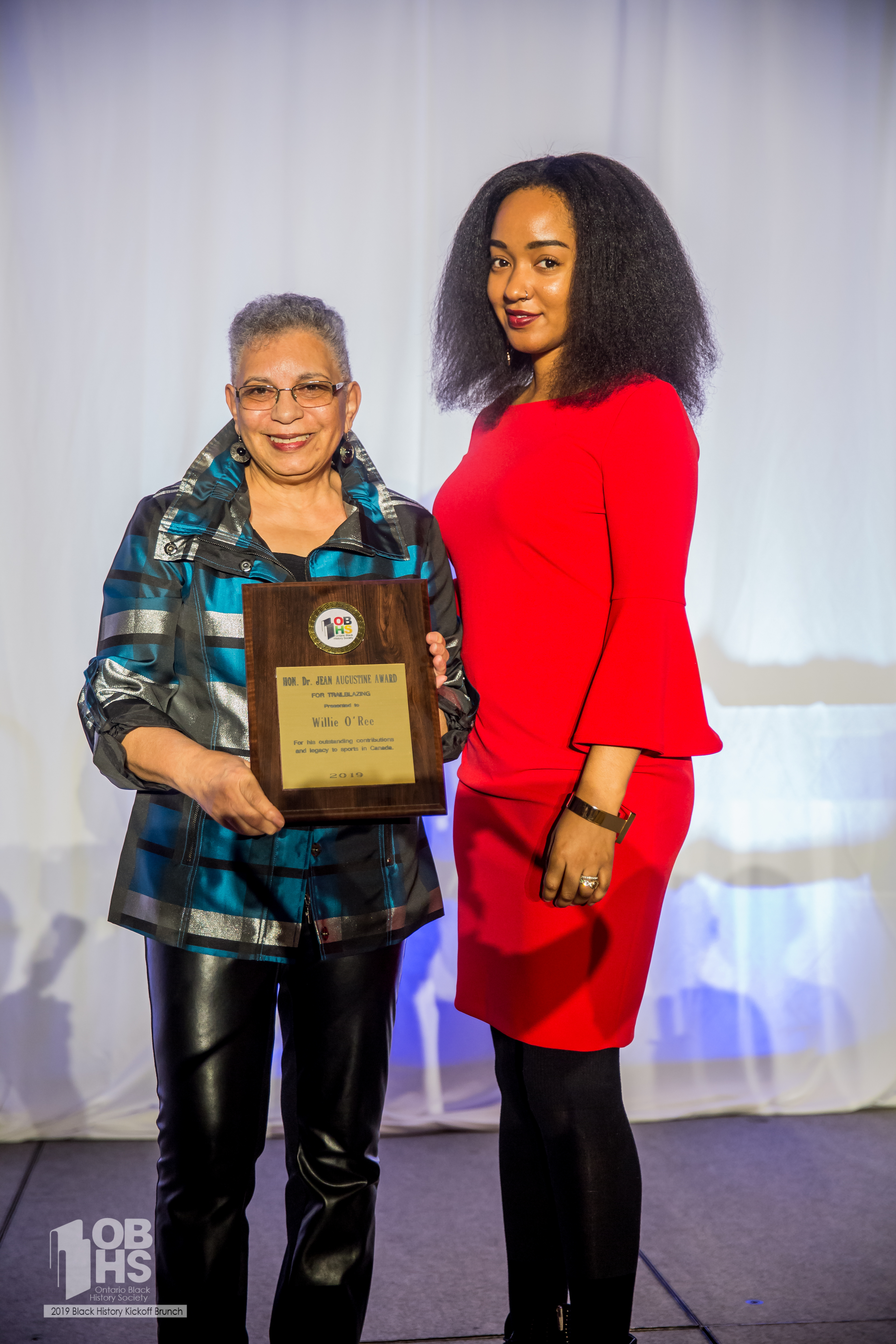 Our host Amanda Parris stands with Bernice Carnegie- receiving an award on behalf of Willie O'Ree.  - photo by www.sayhilondon.com