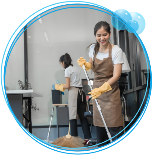 Two women cleaning an office space.