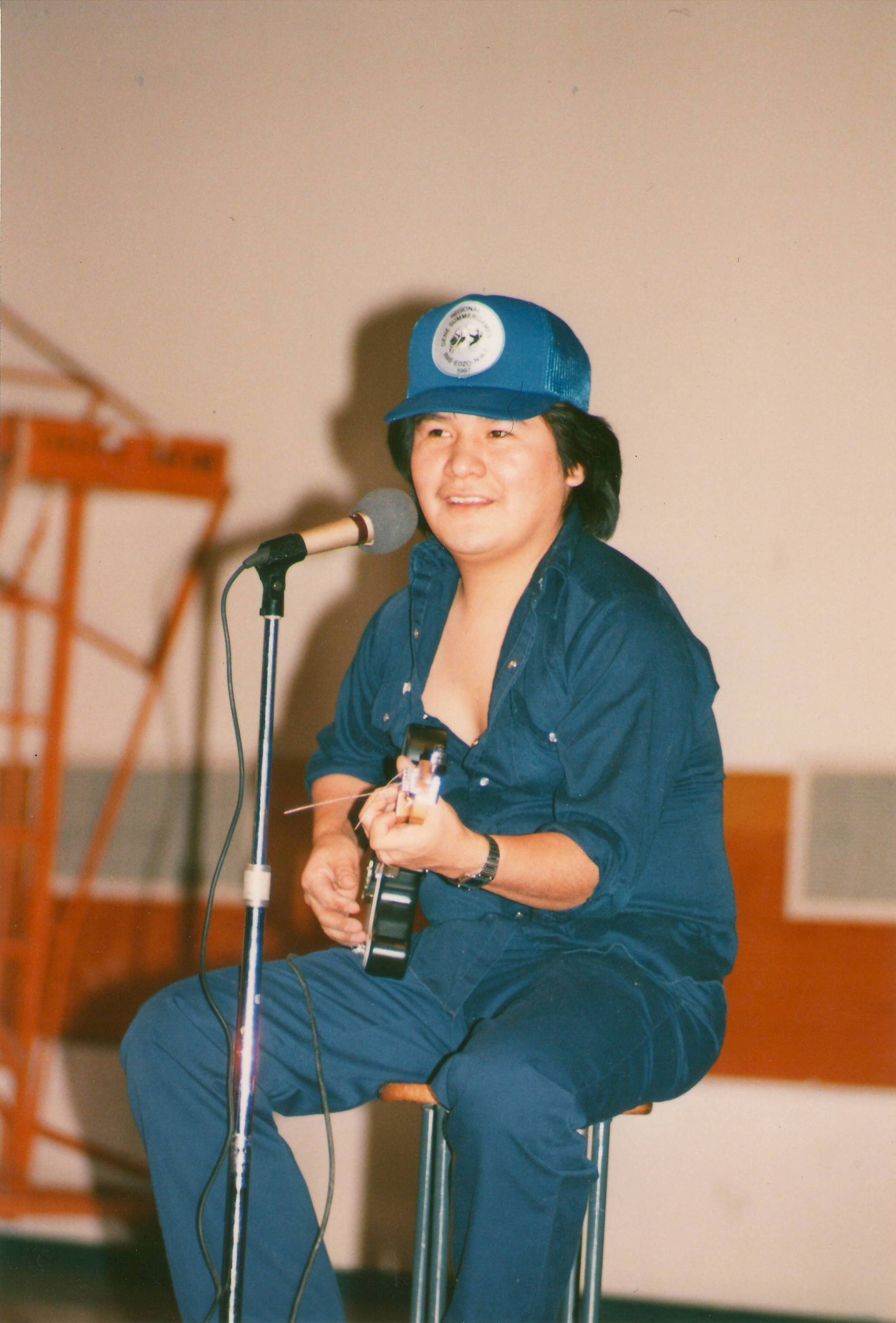 This guitarist is performing at (we think) the Tallcree school Christmas Concert. The photo was taken by Claire Goldsmith and if you look closely you can see the hat reads "Dene Summer Games Rae-Edzo N.W.T 1987" We aren't sure of a date this photo was taken but please Let us know if you recognize this musician or know the date!
--EDIT--
This is Anthony Gon
2017.37.77 / Goldsmith, Claire