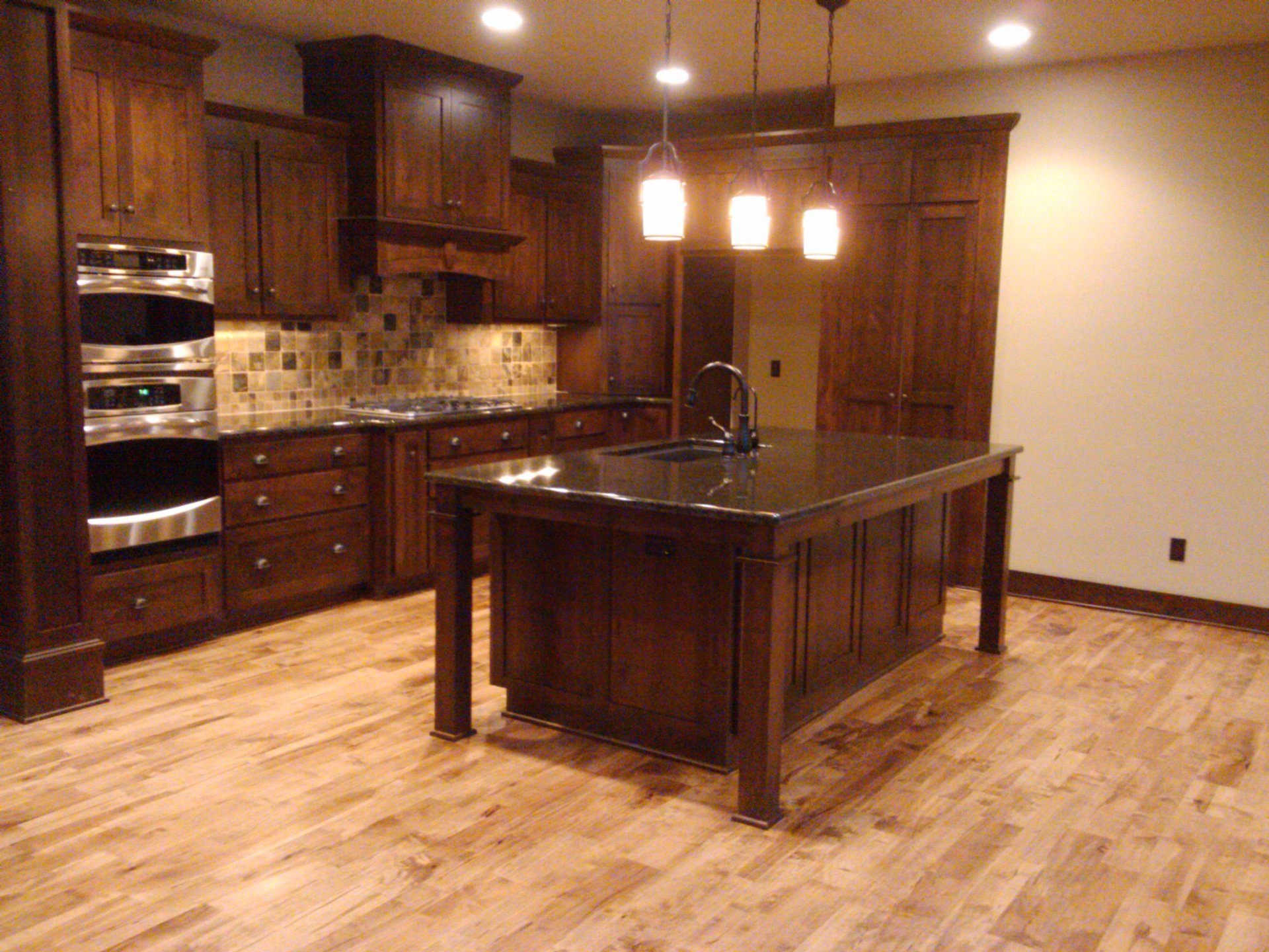 Luxury residential kitchen restored following post-renovation recovery with surfaces cleaned and prepared for occupancy