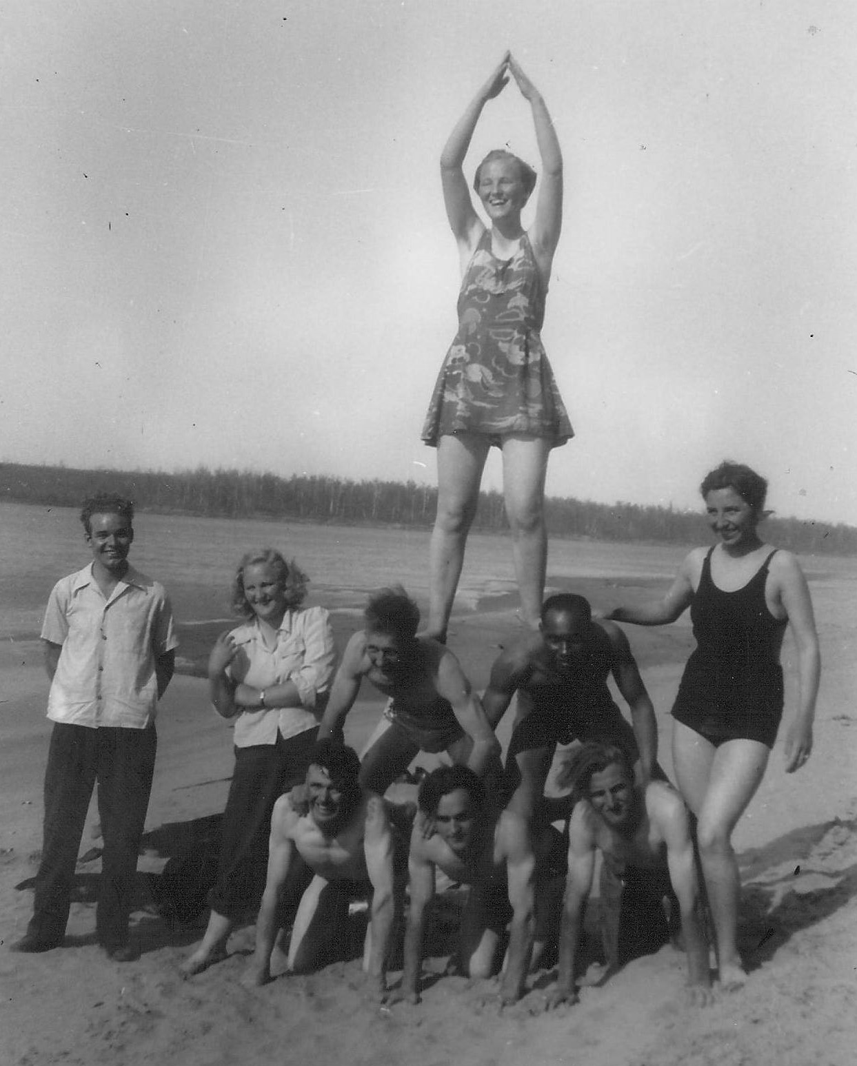 This group of young adults look like they are having a great time one the beach (and judging by the serious farmer tans of the bottom three gentleman a well deserved break)! We aren't able to identify any of them so if you have any leads - please let us know!
990.4.3.34 / Bailey, G. Cook

--Edit--
The lady in the blouse second from the left is Blanche Newman, the gentleman on the bottom right of the pyramid is Jack Newman and the lady atop the pyramid is June Newman. The lady in the black swimsuit far right is Gladys St. Germain (Wortman).