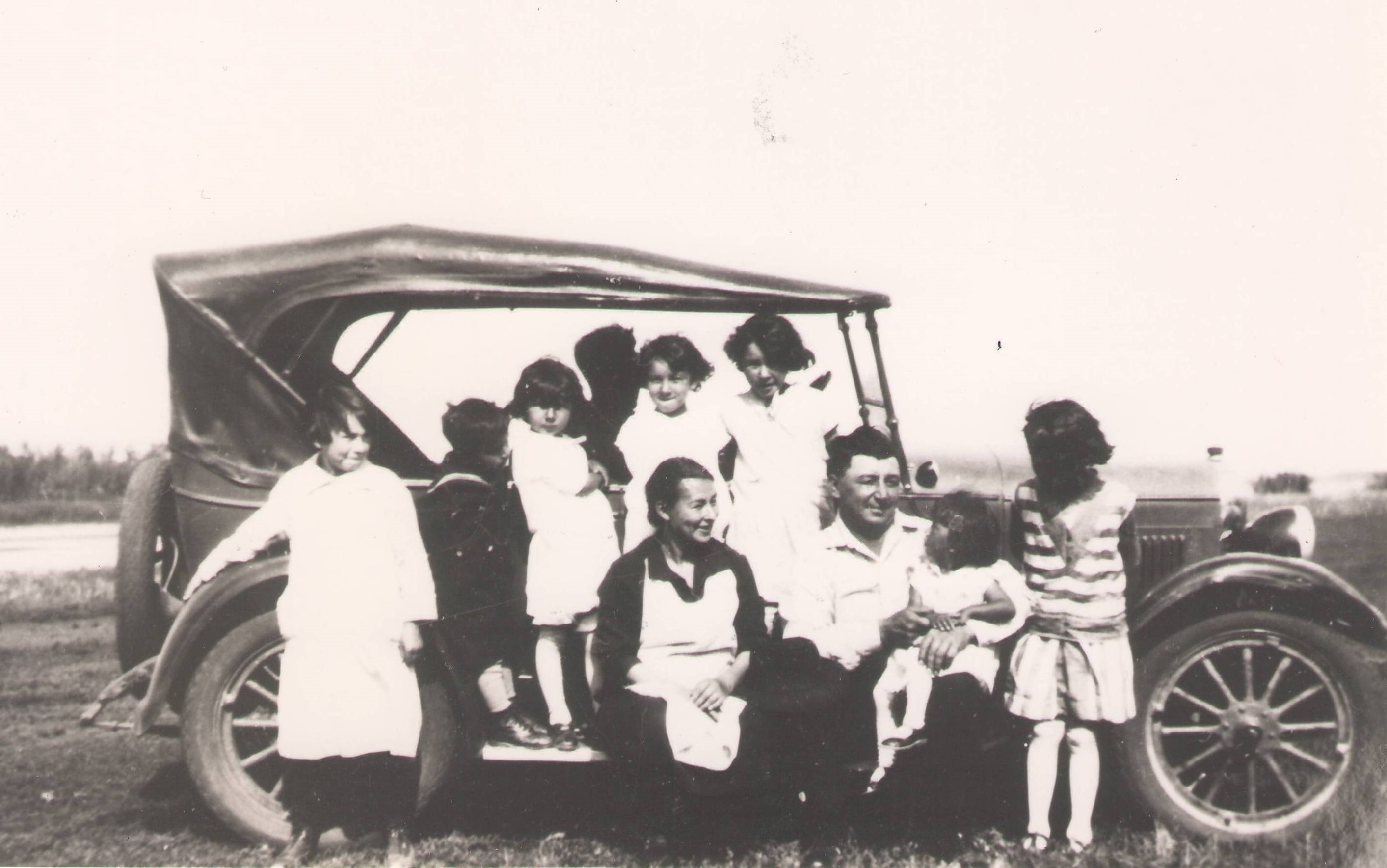 This appears to be a family enjoying their time with what appears to be a 1926 model T Ford Car. Many of the childrens faces cannot be seen but we are hoping you can help us identify the parent couple and some of the children if possible!
990.4.79.235 / Reid, Gordon
