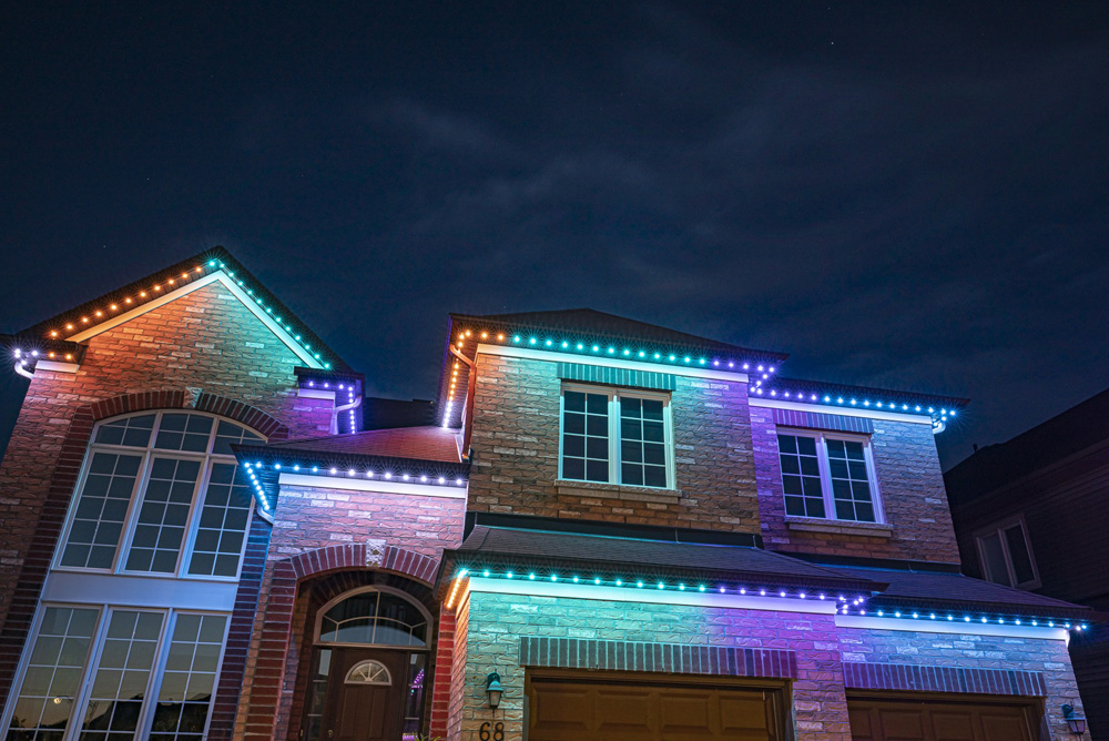 A house lit with pastel lights in the evening.