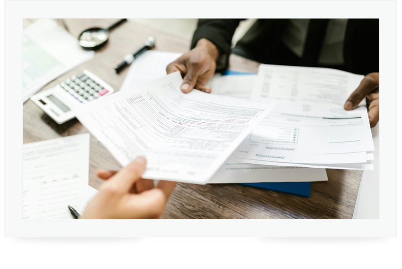 Two people exchanging official documents Two people exchanging official documents