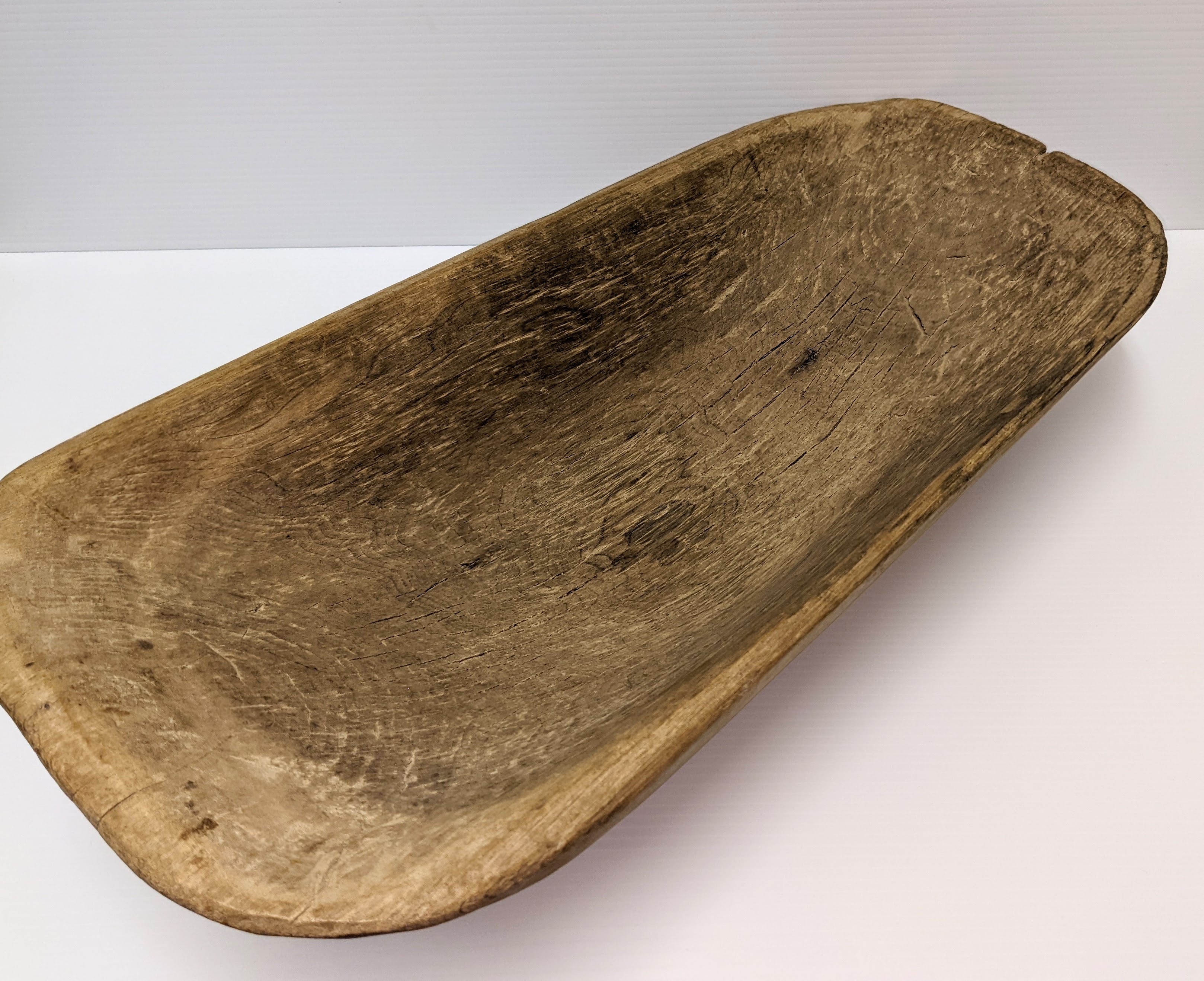 This large wooden bowl is labelled as a babies bathtub. It is 'dug-out' in style meaning it once was a full log that has been carved into its bowl shape. Though we don't have an age of the artifact it's smooth surface and various markings indicate it is well used and washed many a child.
999.03.94 / Hitchcock, Eunice