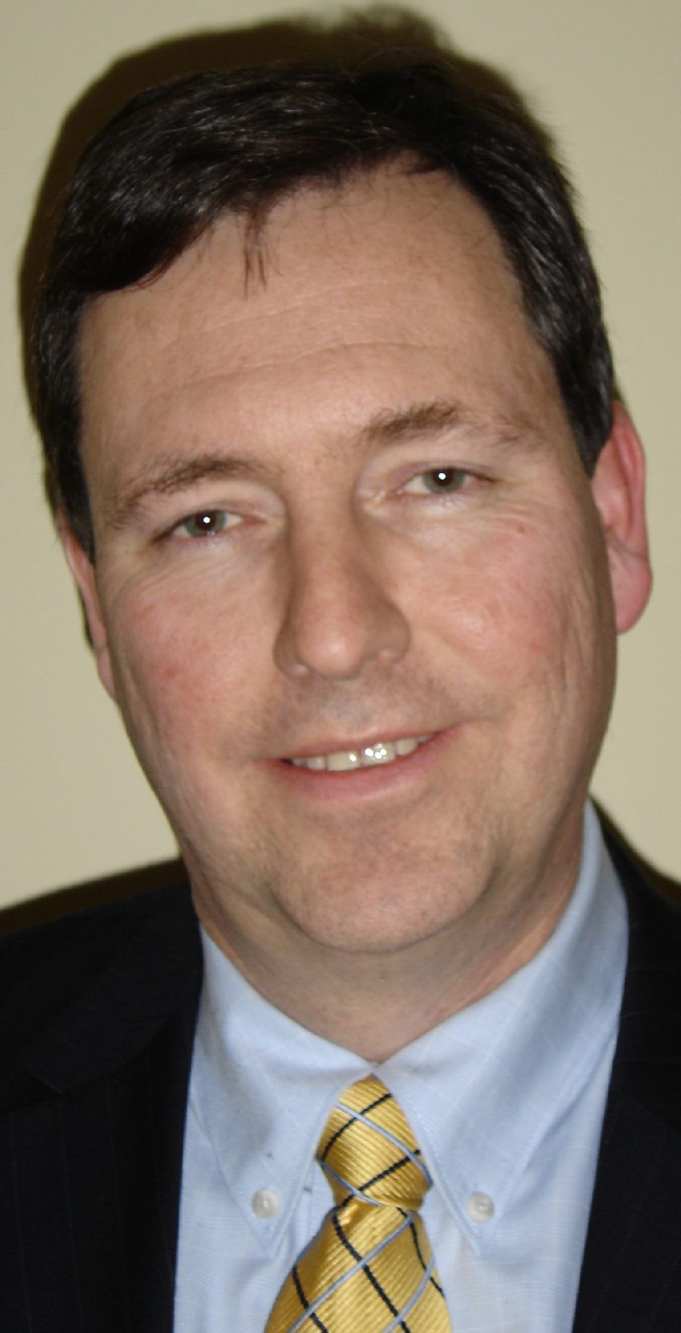 man standing near white wall