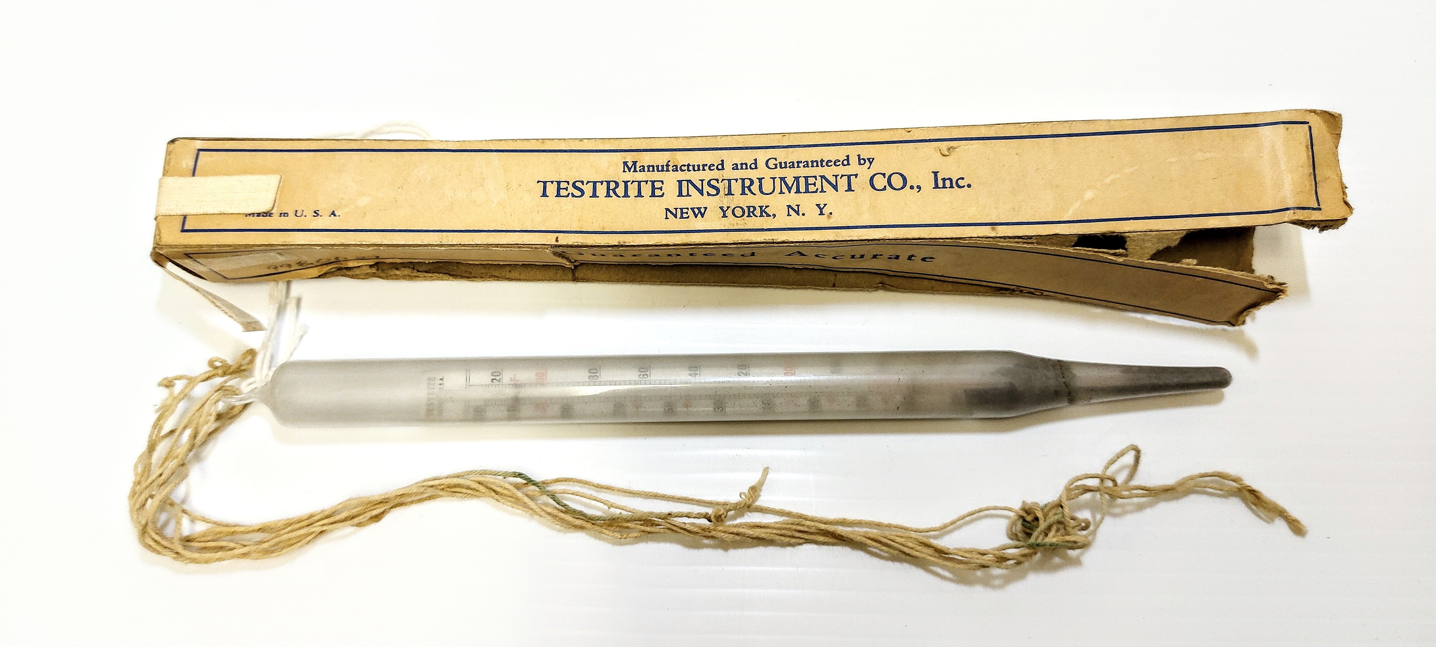 This is a floating Dairy Thermometer. Made in New York, this thermometer gauges temperature with special markings that notate the various stages of milk products. For example, it notates "Cheese" at 85° "pasteurizing" at 165° and "Churning" at 62°. Precise temperatures are very important in producing quality dairy products and this thermometer is labelled as "Guaranteed Accurate". Dairy products were produced throughout the area with notable operations being the Lawrence Ranch,  numerous families in "Buttertown" and  the Newman Farm. 
998.1.27 / Newman, Jack & Pearl