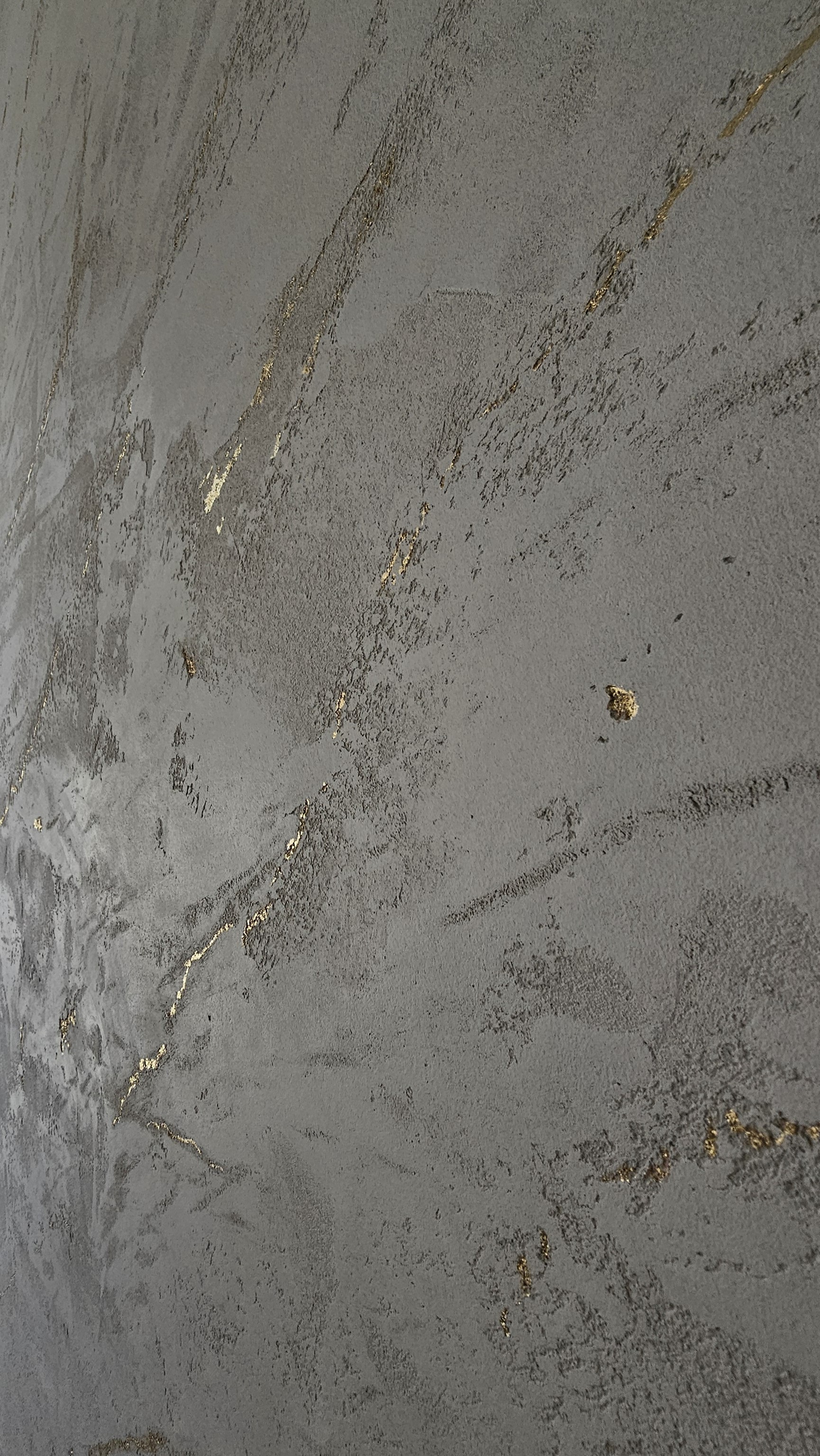 Minimalist living room with a large window, green plant, beige sofa, and modern furniture.