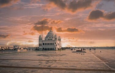 Badshahi Mosque courtyard at sunset with dramatic sky in Lahore, Pakistan