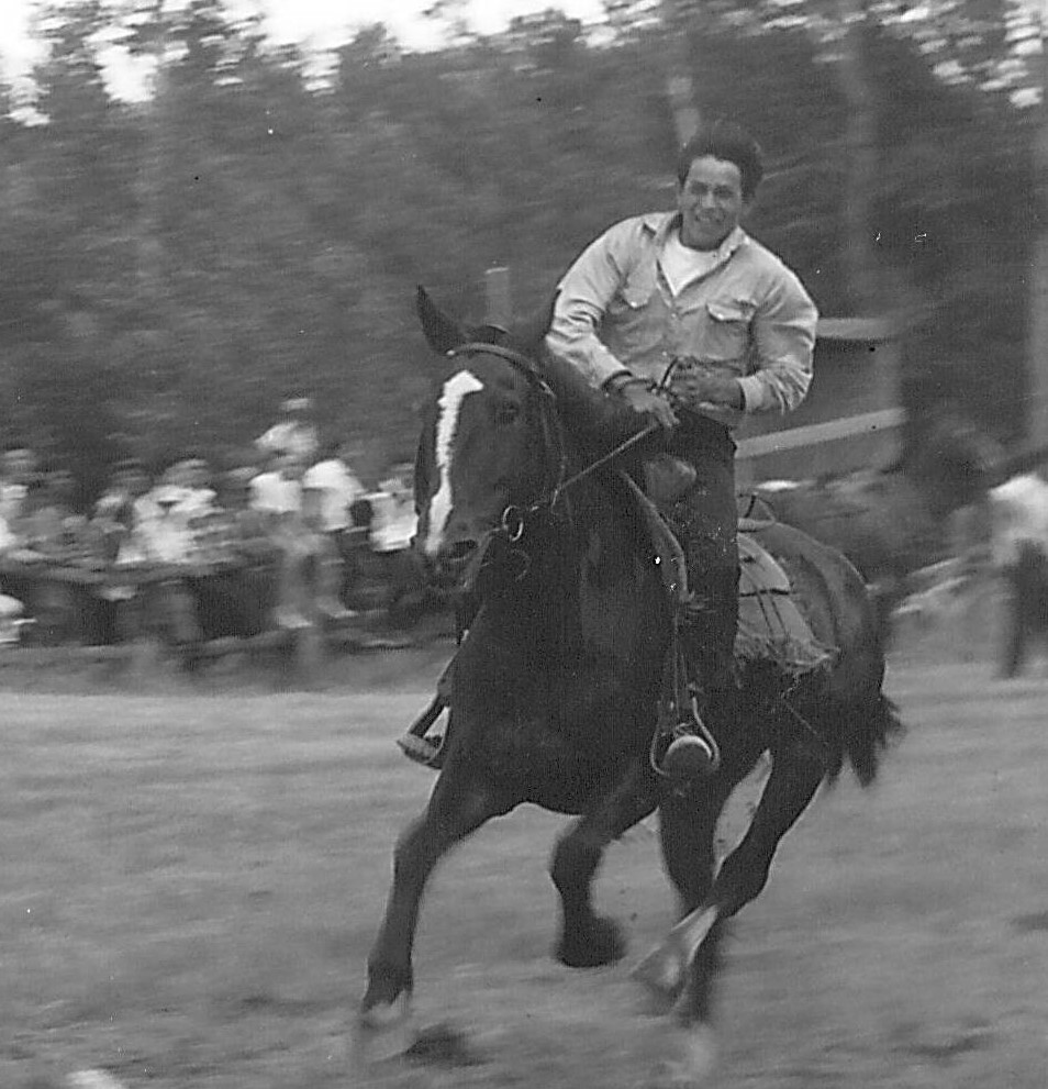 This fellow is running in the horse races at "Sports Day" - and although we can't determine what place he is in - his hair, clothes and blur of the picture indicate he is moving quite quickly! Sports day took place every July 1st at the Rodeo grounds - and though it looks different now - the celebrations happening this July 1st uphold the spirit of this historic event! Let us know if you recognize this racer!
990.4.59.13 / Mandelin, Rose