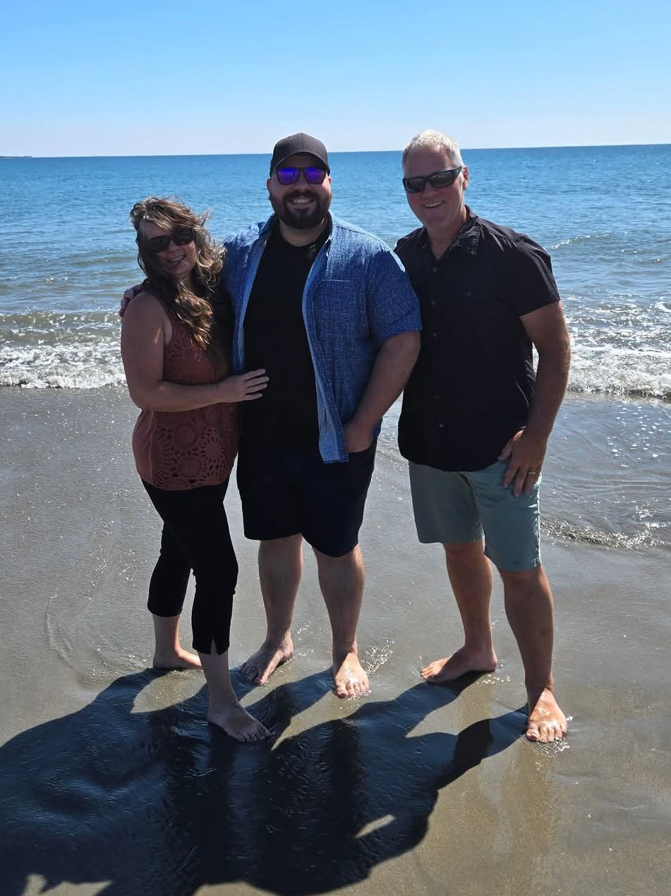Kerry and her Husband with their son  at a beach.