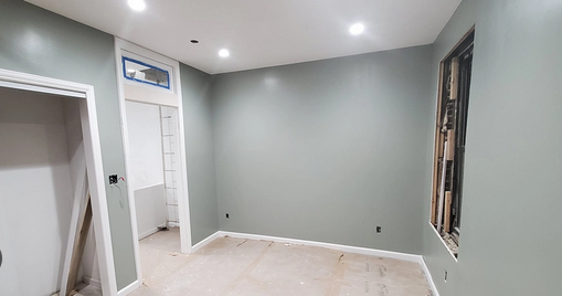 Newly Painted Room with Soft Green Walls and Recessed Lighting