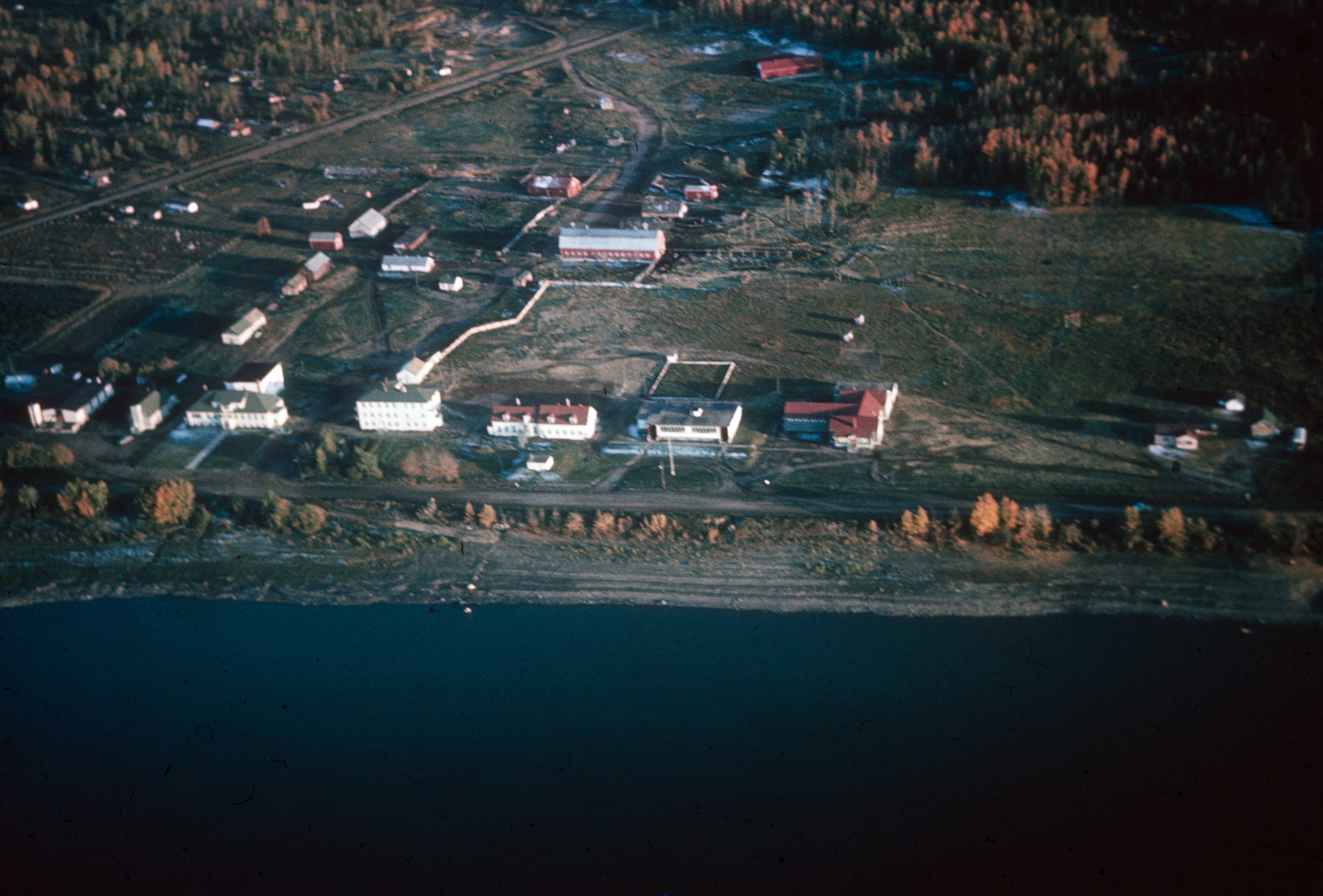 Aerial view of Fort Vermilion 1966. The buildings at centre are the public school and residential school with residences. 
Photo Credit: Anthony  O'Carroll. 