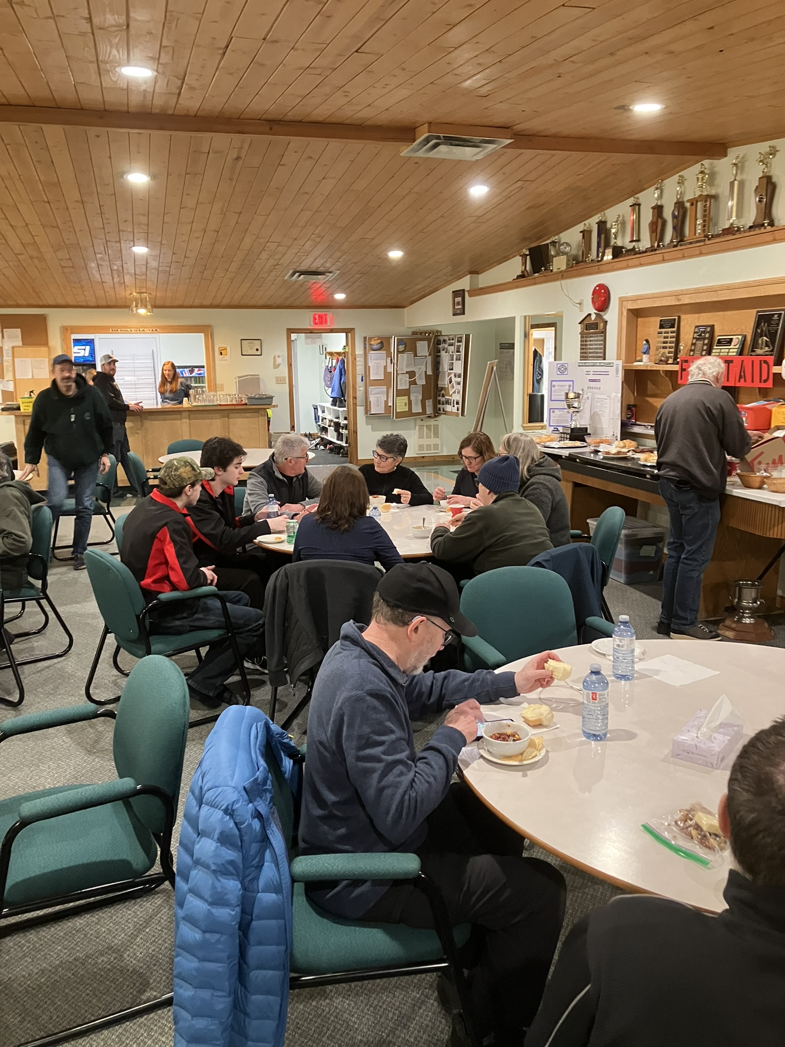 Players enjoying a delicious lunch of hamburger soup, chilli, rolls and desserts