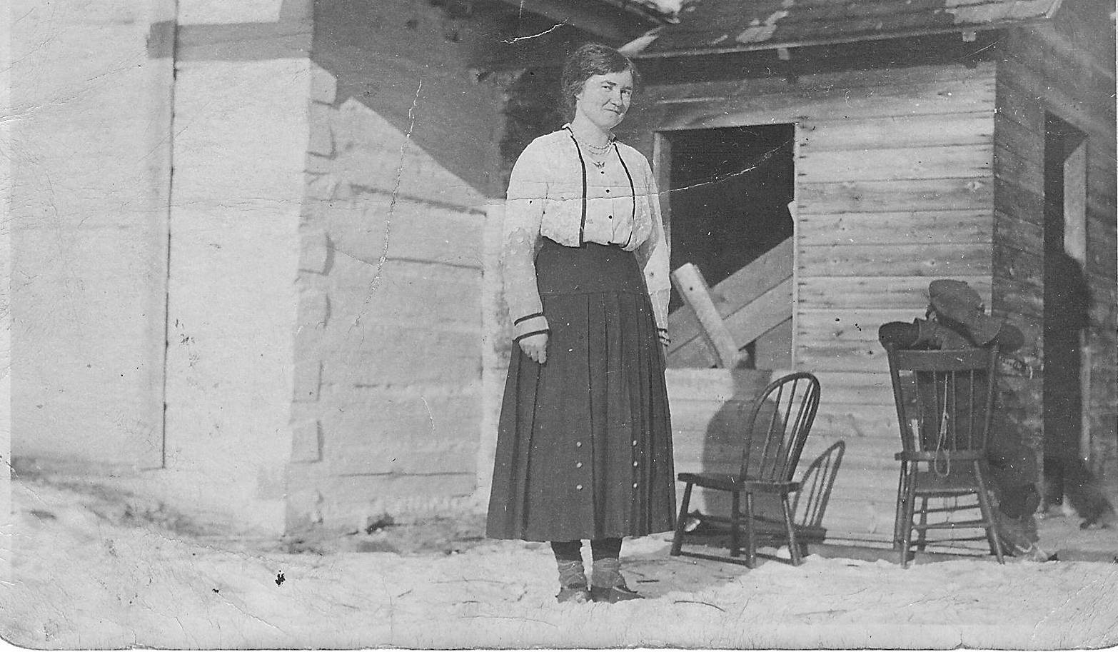 This young lady is potentially a school teacher - though we aren't sure who. If you look close you will notice that what appears to be a pile of clothes on the chair is in fact a child hiding themselves from the camera - and doing a splendid job of it!
2005.24.23 / Schartner, Bob
