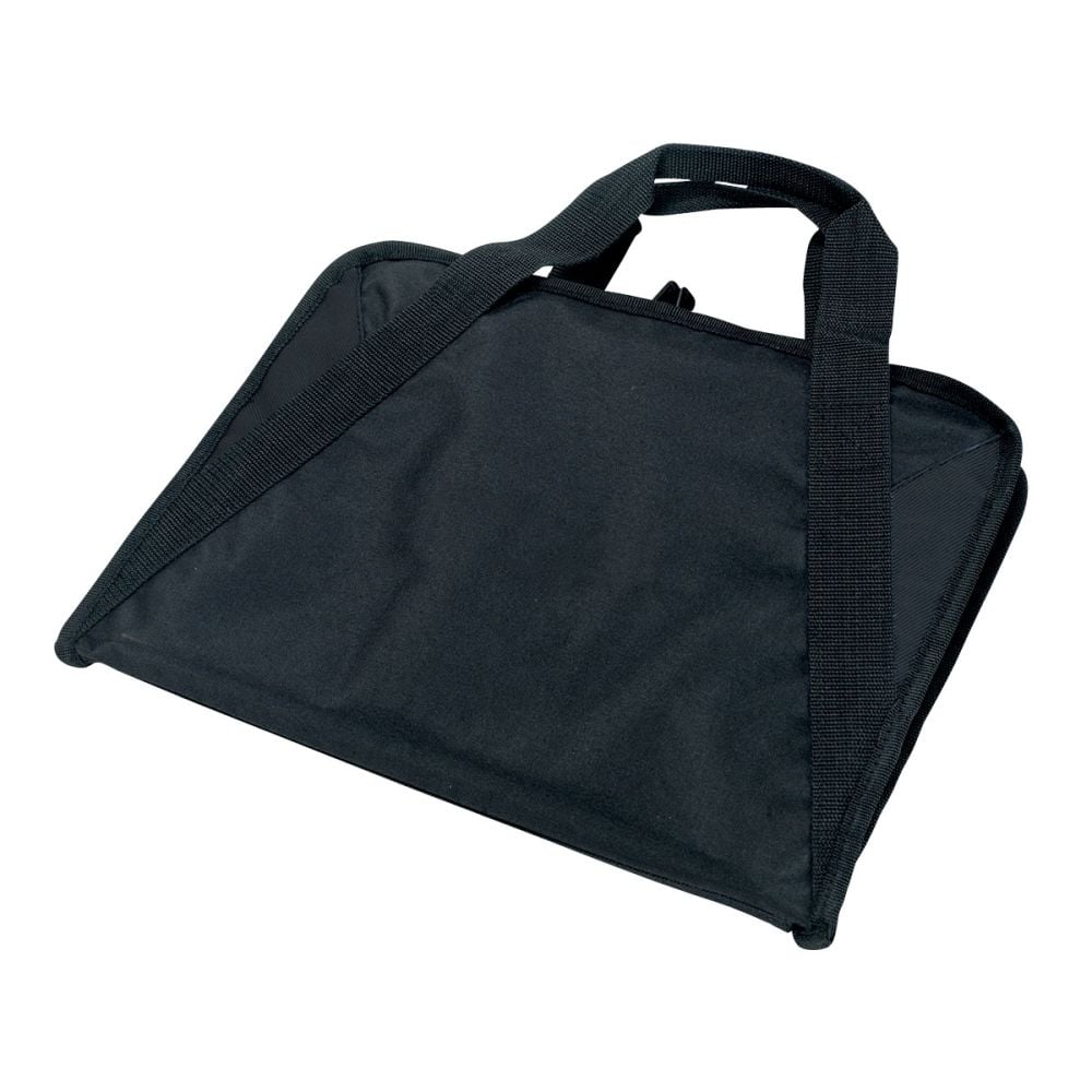 a hand holding a plastic bag over a glass of orange juice