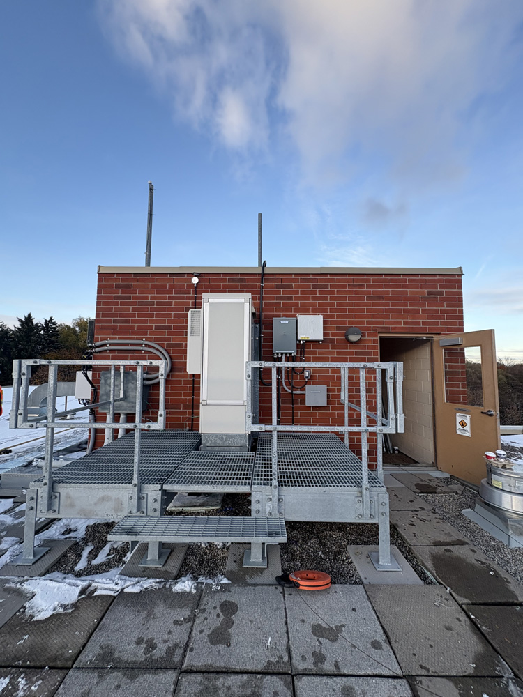 Electrical boxes on the outside of a small brick building