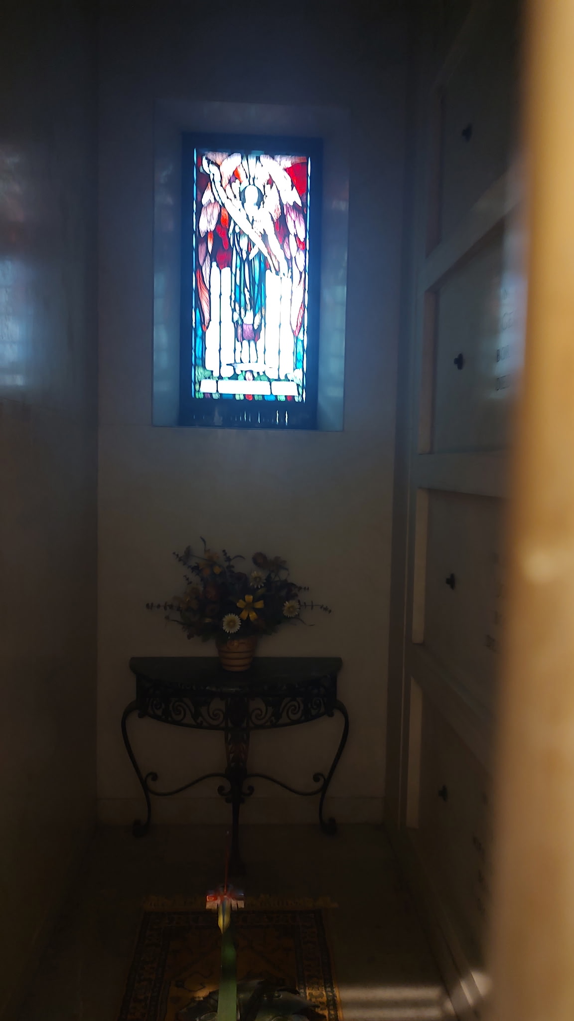 a woman dressed in a ghost costume standing on a tree stump