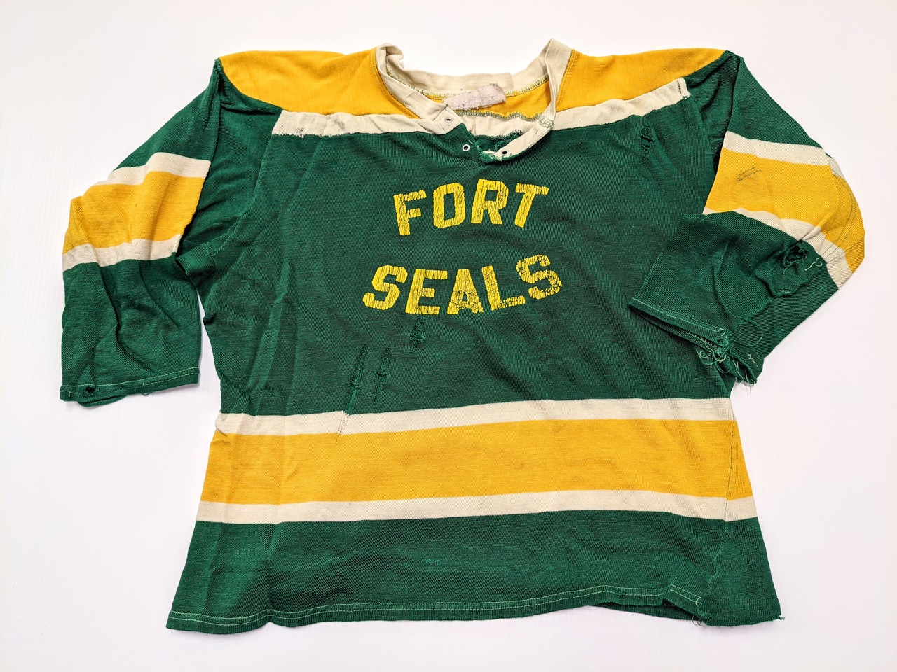 This hockey Jersey comes from the oldest Hockey Team in Fort Vermilion - The Fort Seals. Sponsored by the S. Stephens store this team dates back to the 1940's. The Jersey is small in stature with short sleeves and  wide dimensions typical of a goalie jersey to accommodate extra padding. We do not have information on the significance of the name "Seals"

05/07/2021
2020.59.23/ Smith Louise