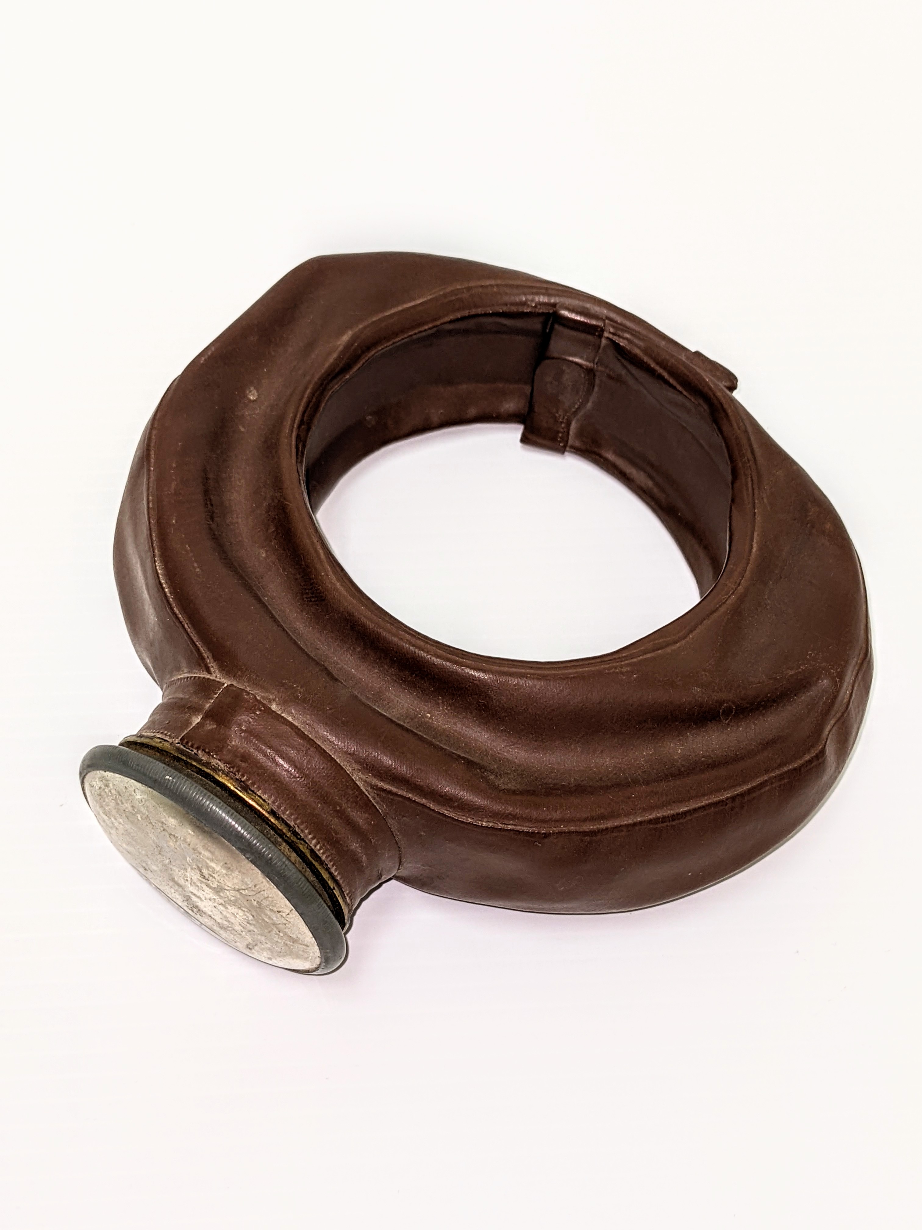 This strange looking bottle is called a "Tonsillectomy Bag". Manufactured by the Davol Rubber company of Rhode island in the 40's and 50's, this bag assisted in soothing a patients throat after having a tonsillectomy. The bag was filled with water then frozen / chilled so it could be wrapped around the patients neck - the cool temperature aiding in reducing swelling and pain. It is made of real rubber and has become very brittle - with the invention of pliable bags like ziplock, these unique devices were quickly phased out of medical practice.
02/05/2022
2004.18.01 / Simpson, Ena