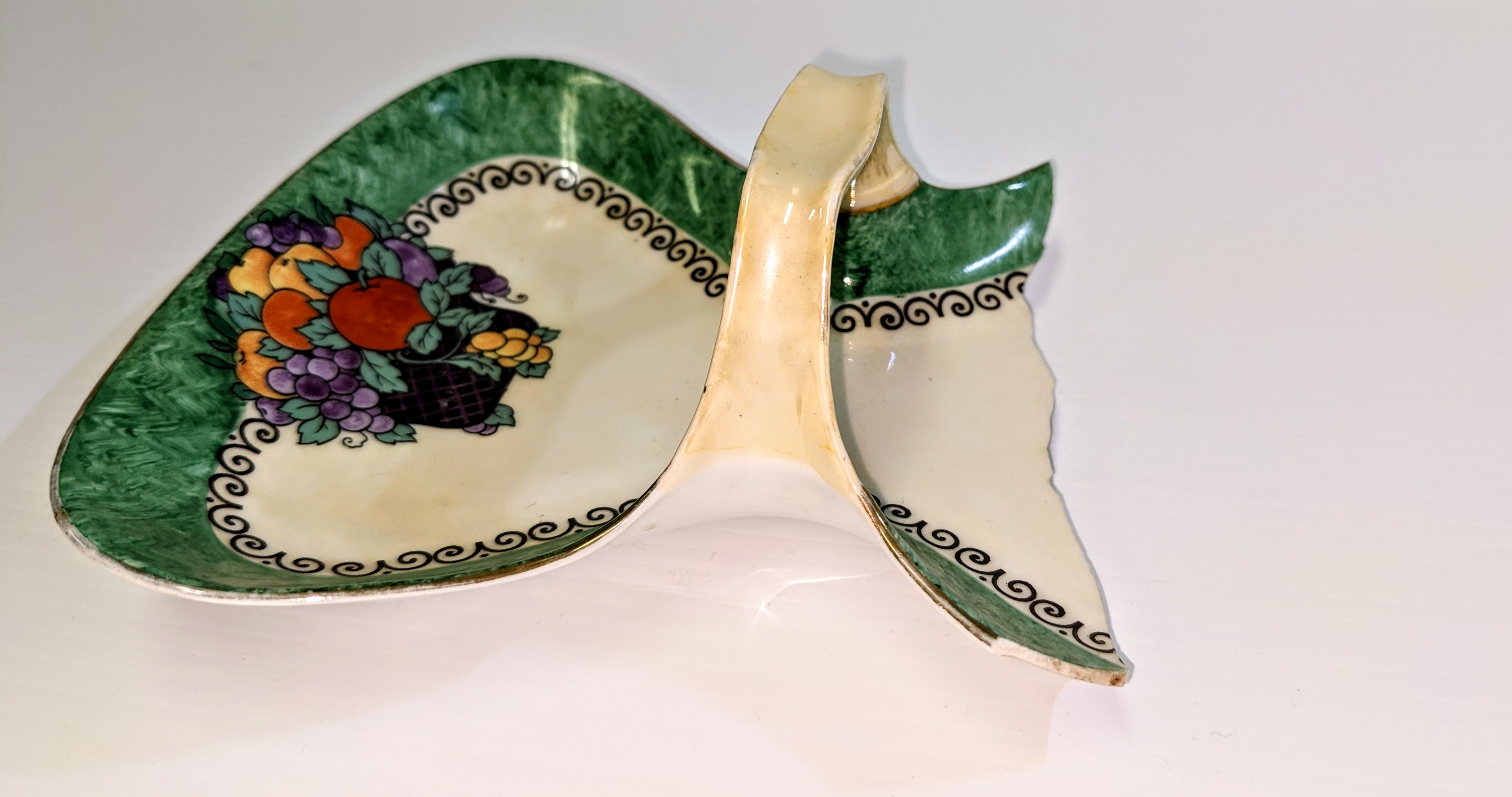This is a candy dish (well 3/4 of it any way) that was found in the Rose house at Prairie Point. Charles and Hilda Rose moved to Prairie Point from Idaho in 1926 where they lived in a tent until mid November when Sheridan Lawrence and a crew of 4 men built them a cabin in 6 days. This dish is hand painted with hints of Art Deco style and is made by Royal Silesia - a German company that produced china from 1920-1940.
2002.253.12.39 / Toews, Al + Marilee
31/10/2022