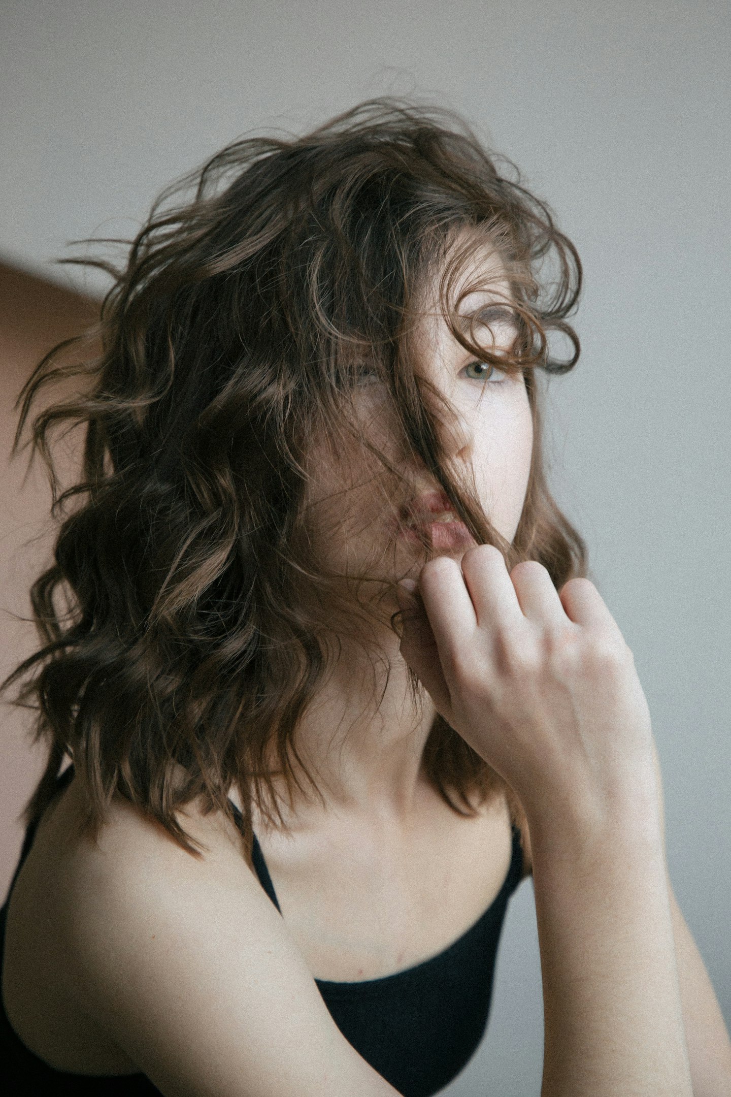 woman in black spaghetti strap top woman in black spaghetti strap top