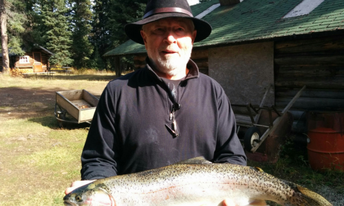Man With a Hat Holding Trout