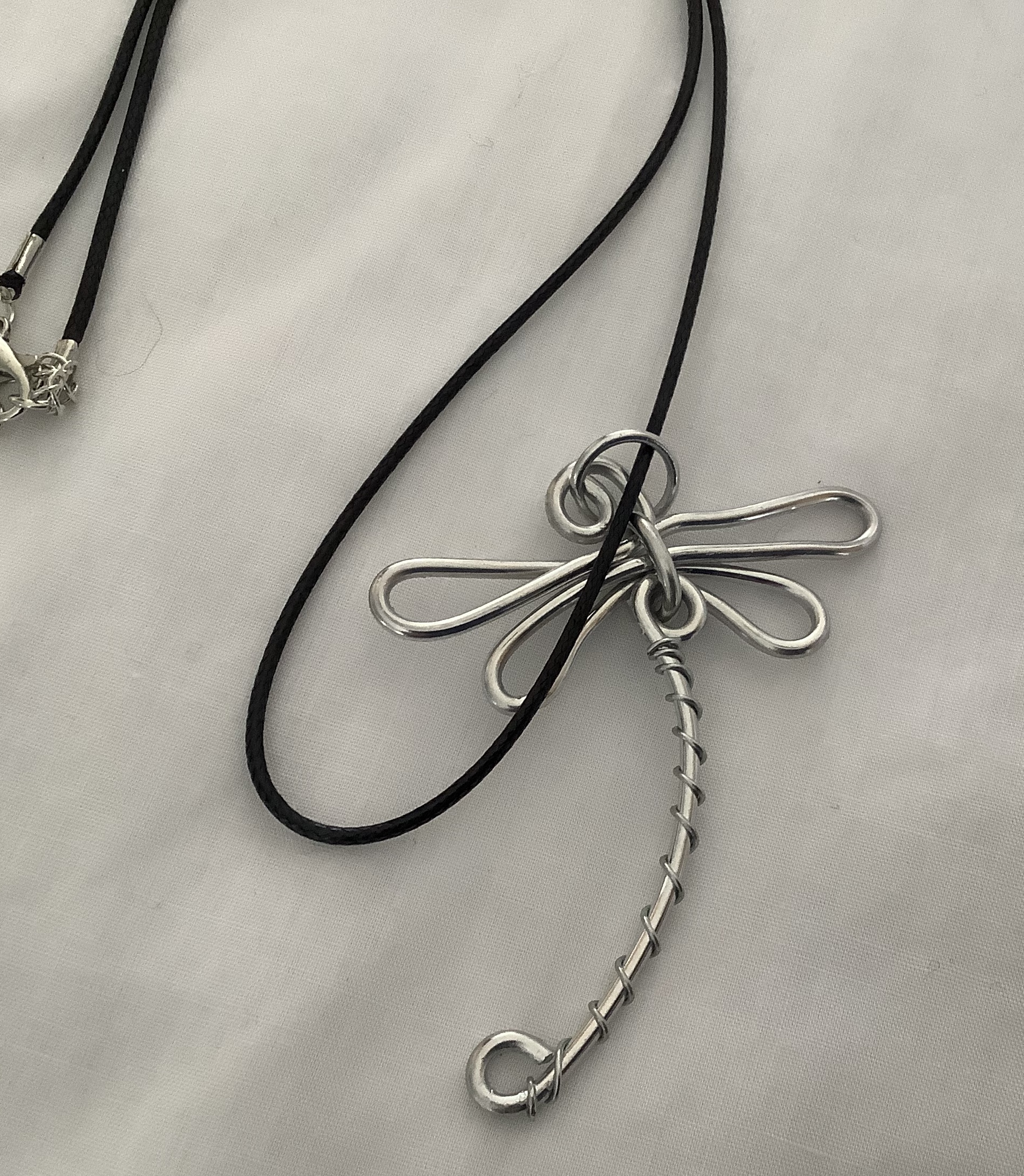 Dragonfly Pendant is hand wired using silver or aluminum wire.  The “Dragonfly” symbolizes change, transformation adaptability and self-realization. If a dragonfly lands on you it is a sign of good luck.  Price $30.00