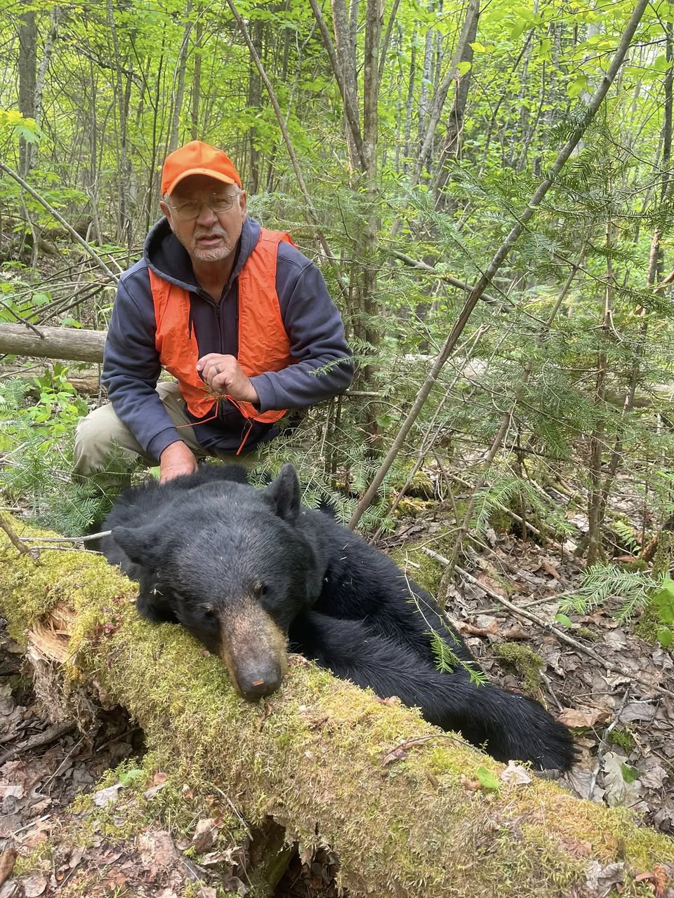 Hunter celebrating a successful Ontario black bear hunt with Wild North Outfitters.