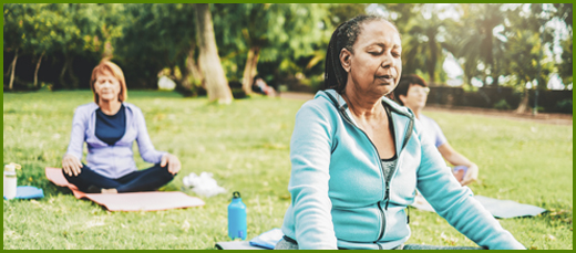 A senior woman meditating outside
