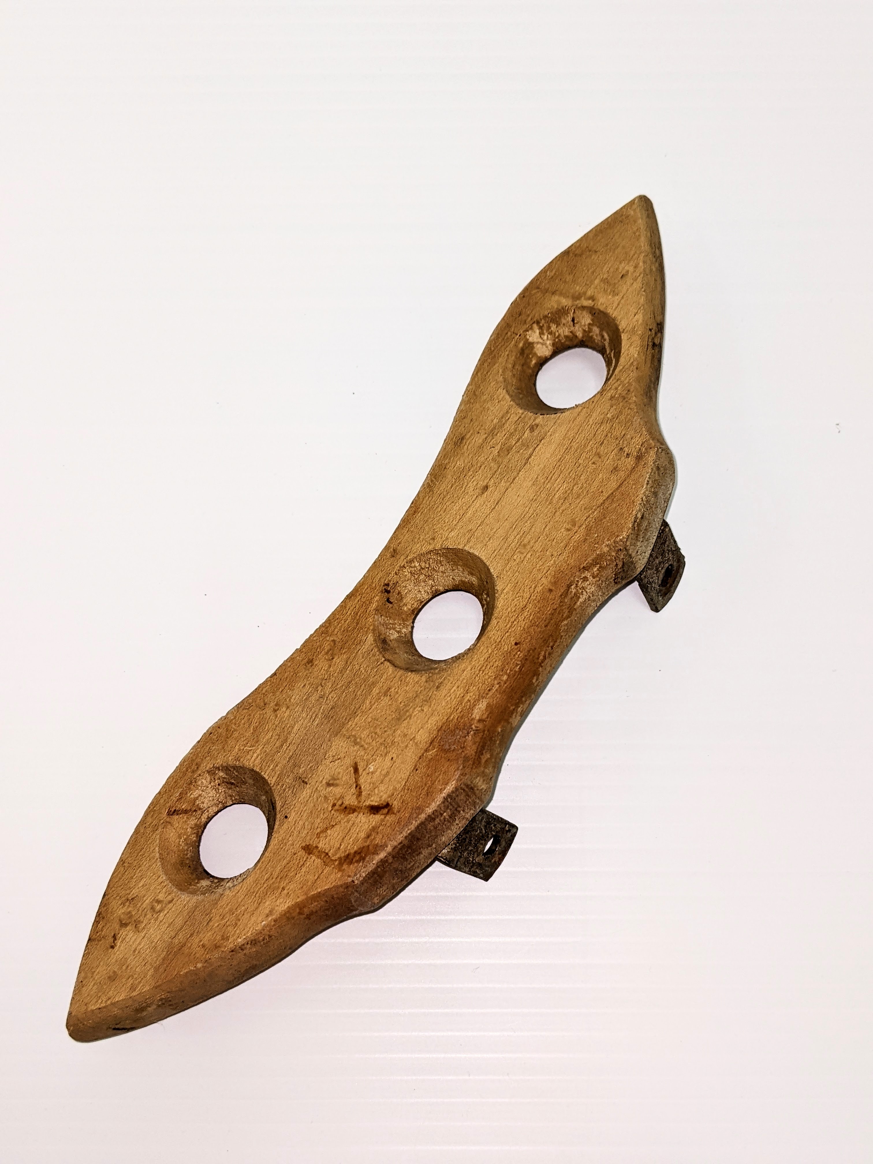  This oddly shaped wooden object is only part of a larger whole. The metal brackets on the back side allow this wing shaped piece to be fastened to a central pivot point. Upon cranking on a handle multiple of these wing shaped paddles would spin inside a bucket churning the contents within - eventually forming ice cream! The holes aid in agitating the contents and make spinning the paddles much easier!
2000.03.20.02 / Campbell, Jean
04/07/2022