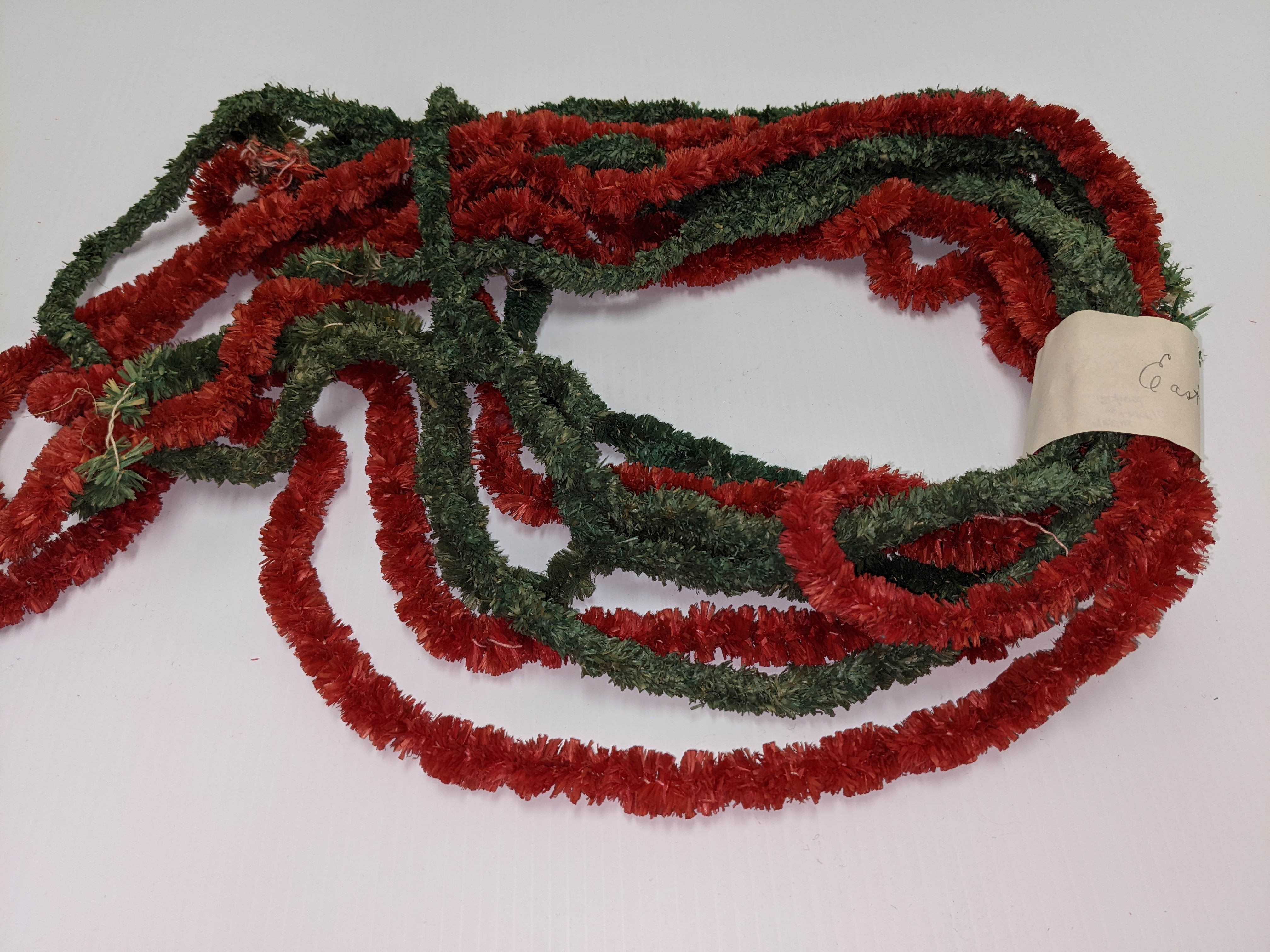 Look at this beautiful garland that once adorned many a Christmas tree! It's made of a natural fibre (potentially straw or grass) sewn and twisted together along a string. The garland was then dyed to get rich red and green colours. Though we are unsure of the time period this artifact comes from - it is very fragile and takes great care to prevent it from flaking apart!

13/12/2021
2002.226.118.02 / Campbell, Jean