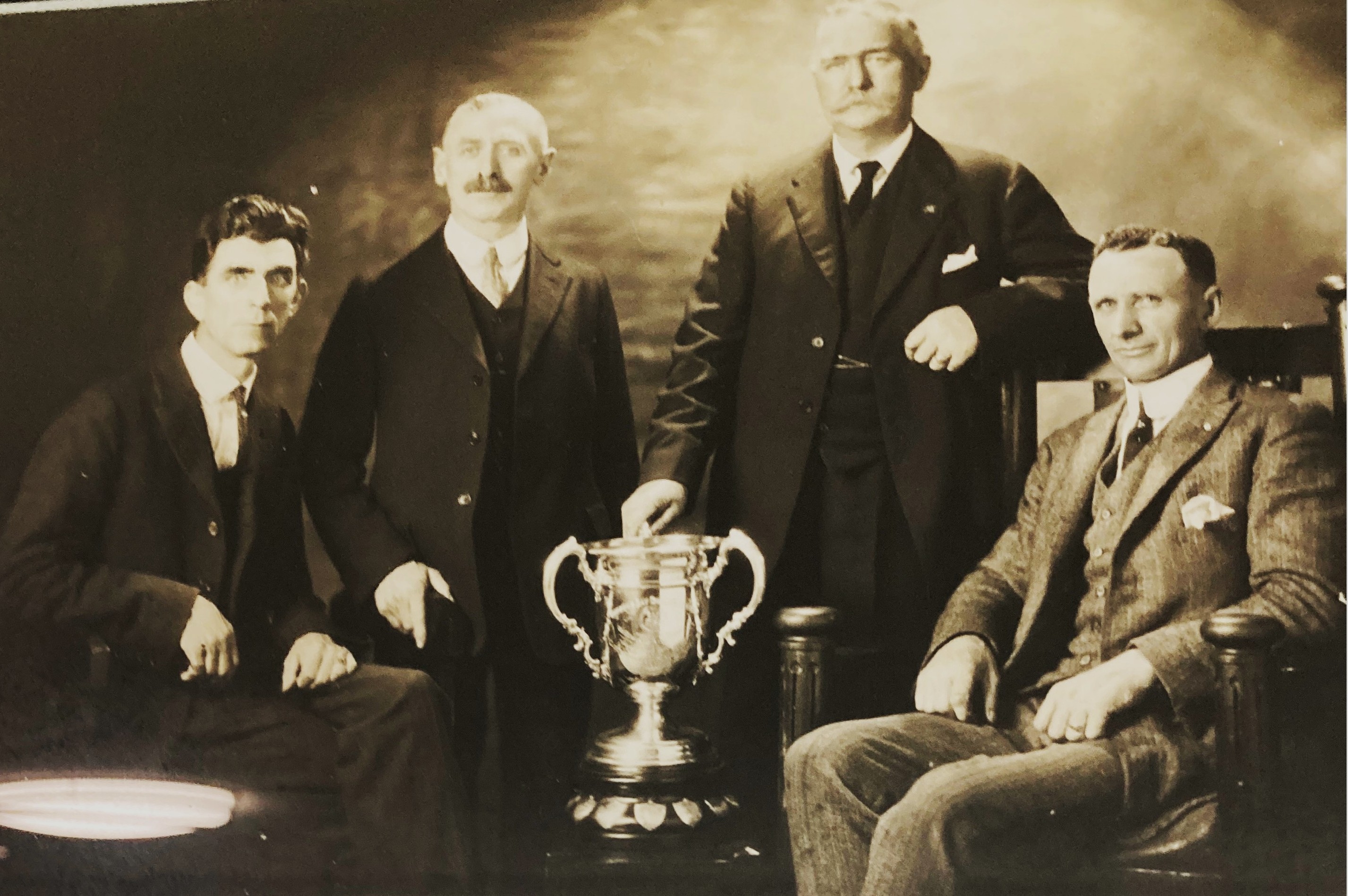 Bowling ball on green lawn with white pins in a sheltered area, surrounded by trees on a sunny day. Bowling ball on green lawn with white pins in a sheltered area, surrounded by trees on a sunny day.
