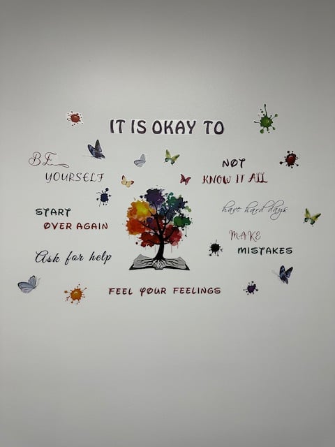 A picturesque garden path lined with vibrant flowers and manicured shrubs, bathed in warm sunlight.