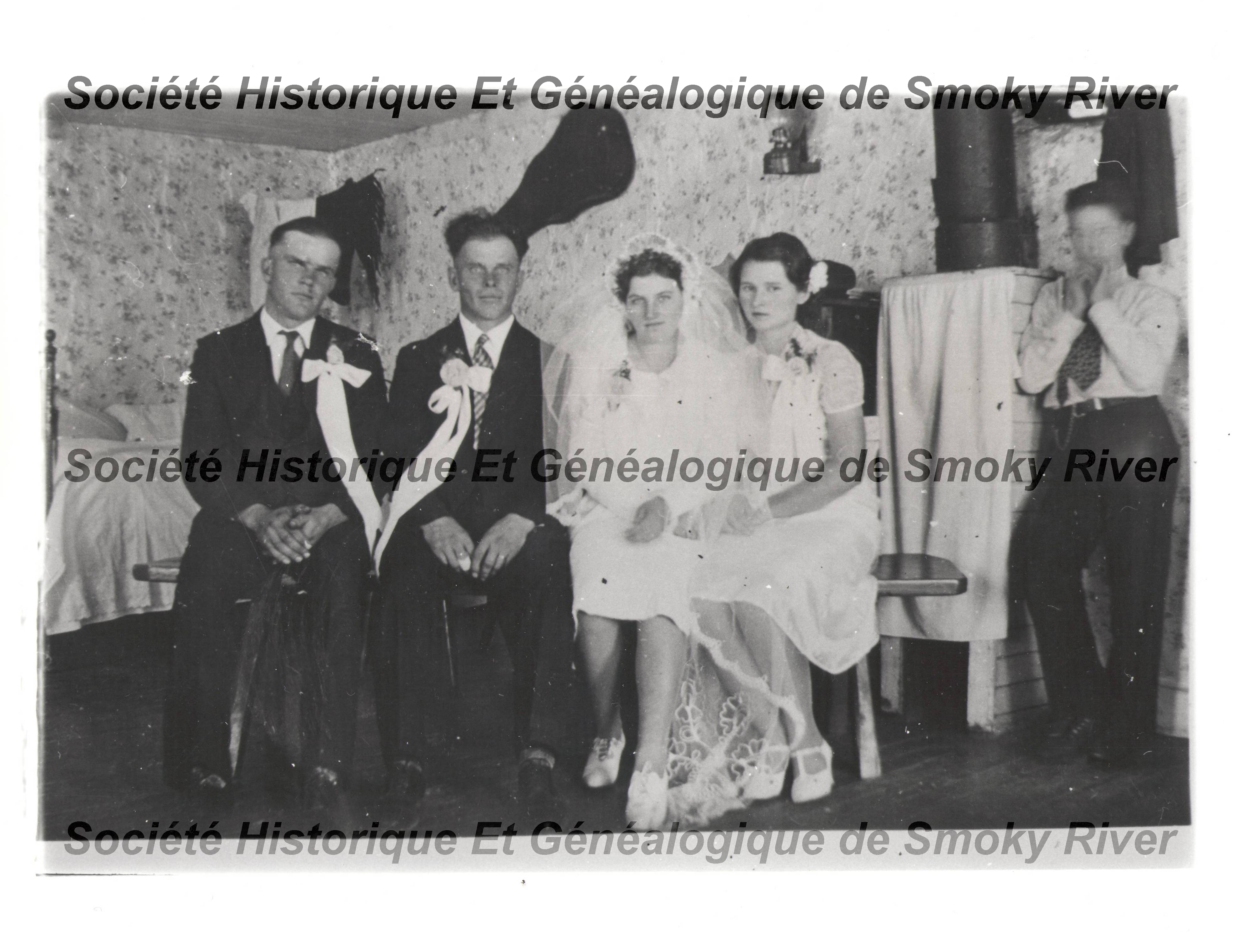 This is labeled as "the Marriage of John Rygus and Katie Kuieiuk" - but we don't know who is who in the picture! It appears that the other unknown couple is also getting married as their attire is quite similar. The date is November 3 1940. John Rygus was the son of George and Katherine Rygus - based on pictures of those two - our best guess is that John is the fellow far left. We don't have a reference point for Katie.
2006.01.243 / Societe Historique et Genealogique de Smoky River
--EDIT--
John and Katie are the centre couple and it is believed the groomsman on the left is Johns brother Alex and the bridesmaid on the right is Ann Swarnitski.